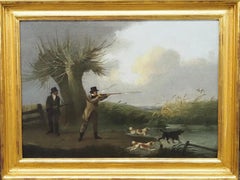 Two Gentleman duck shooting over spaniels