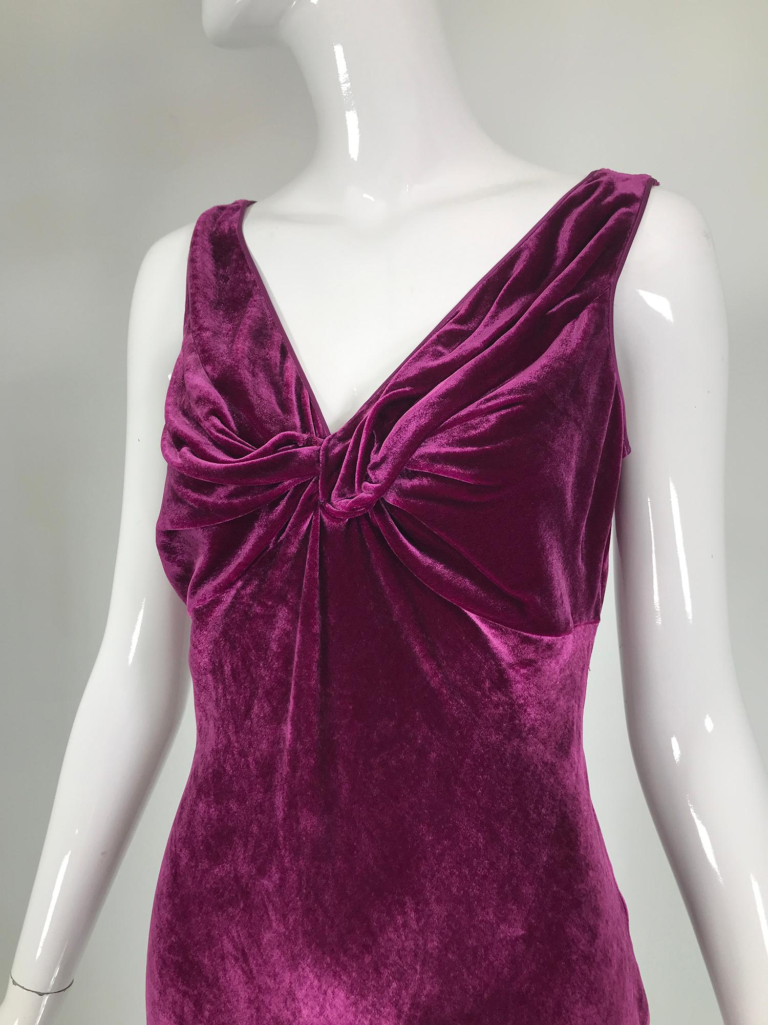 John Galliano 1930s Inspired Bias Cut Wine Velvet Evening Dress, early 2000's. Beautiful velvet dress with a gathered knot bodice front & V back neckline. The dress is fitted through the torso, hip & thigh and flares at the hem. The bias cut allows