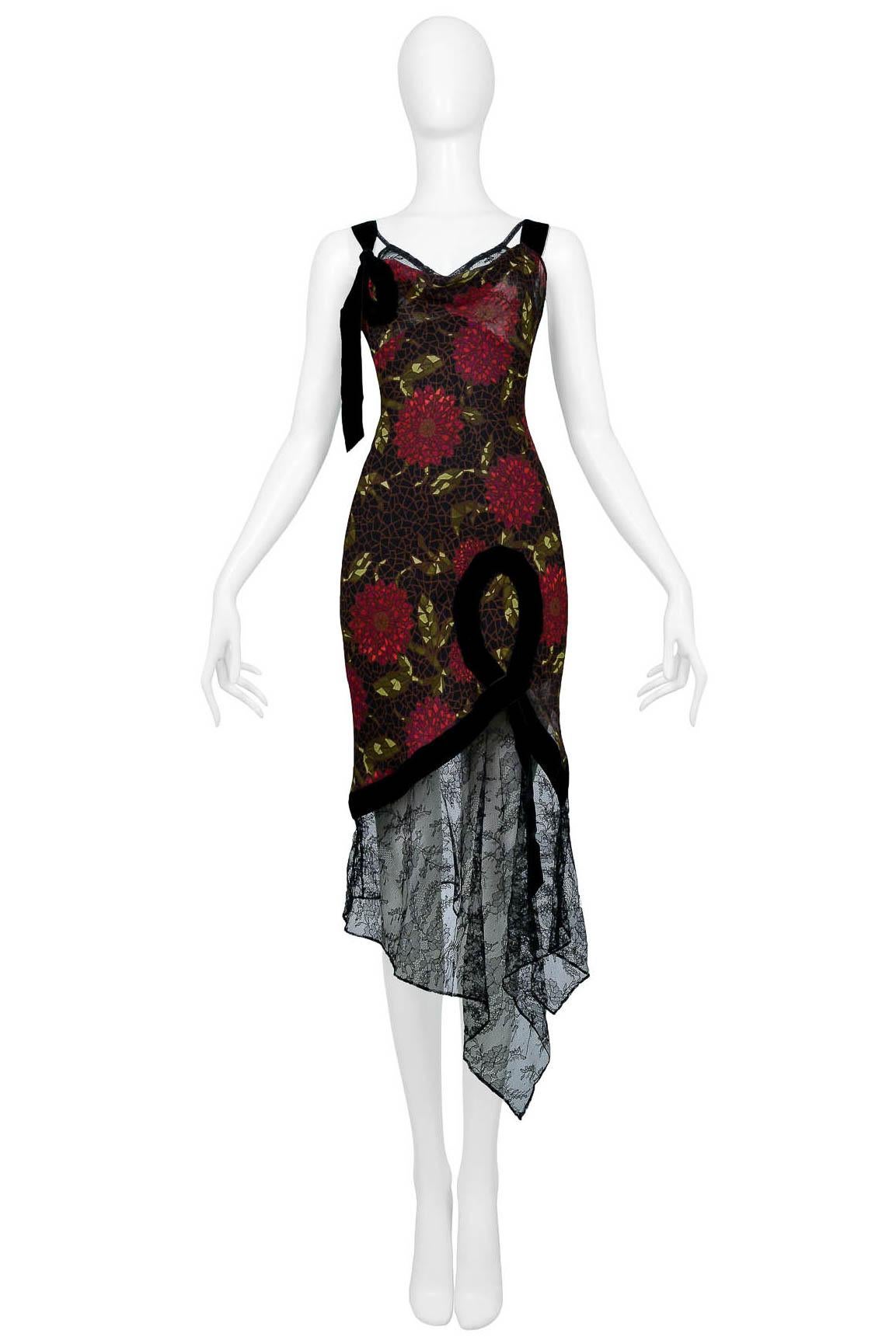 Resurrection Vintage is excited to offer a vintage John Galliano 90's black silk cocktail dress featuring lace inset brassiere and asymmetrical hem, floral pattern, and black velvet ribbon detailing. 

John Galliano
Size: 4
Silk
Excellent Vintage