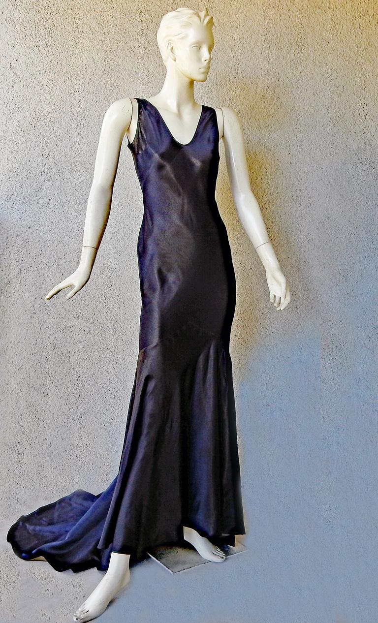 Lovely Harlowesque 1930's style bias cut gown by John Galliano.   Fashioned of navy silk backed in antique gold silk interior.  V neckline and deep drape open back.  Excellent tailoring boasts godet panel skirt.  Overhead entry.  Designed at a time