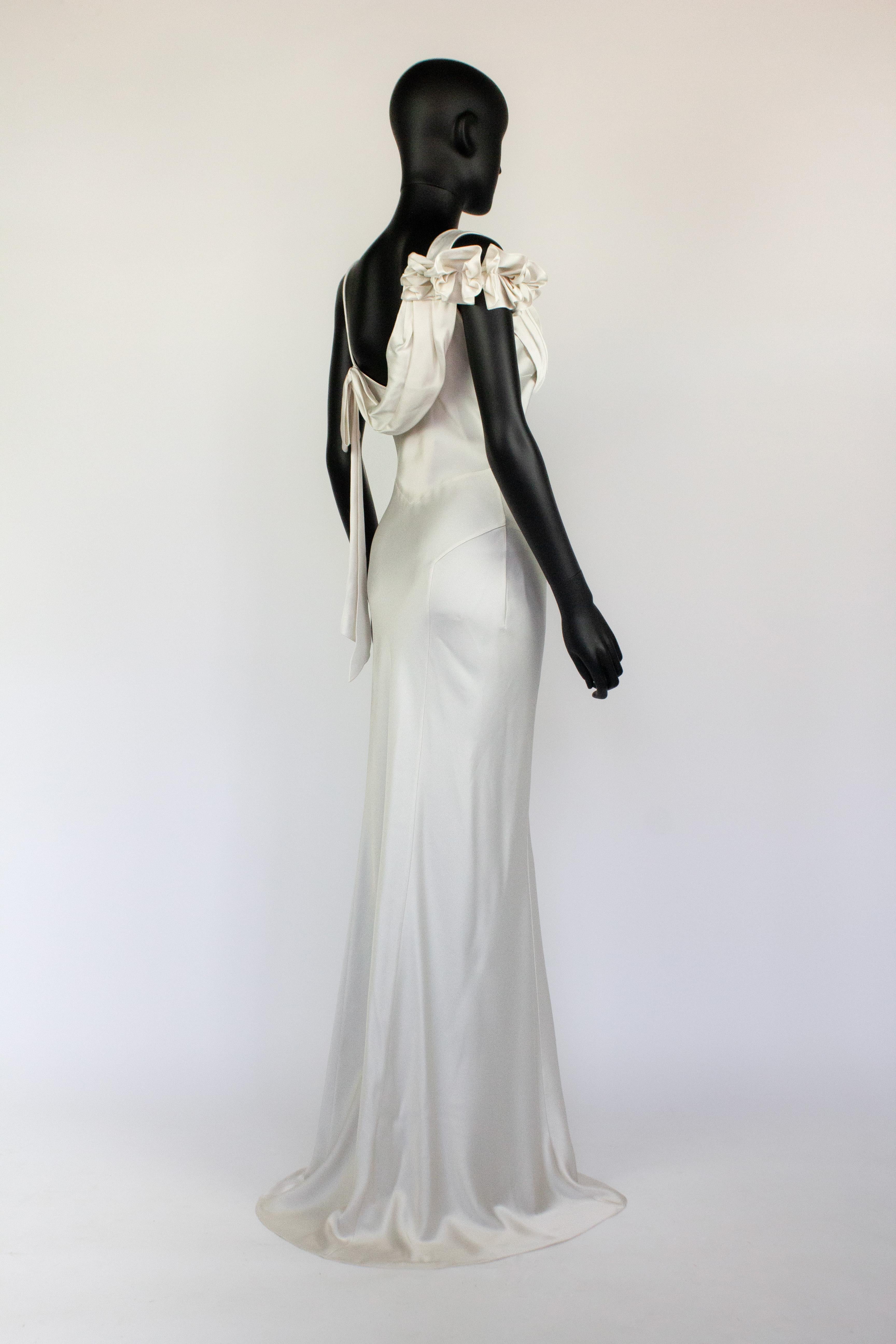 John Galliano white satin dress with draped neckline and floral detail on sleeve. Circa Spring/Summer 2011. Would make a magnificent and one of a kind wedding dress from an iconic designer.

Condition
New with tags and original hanger

Marked