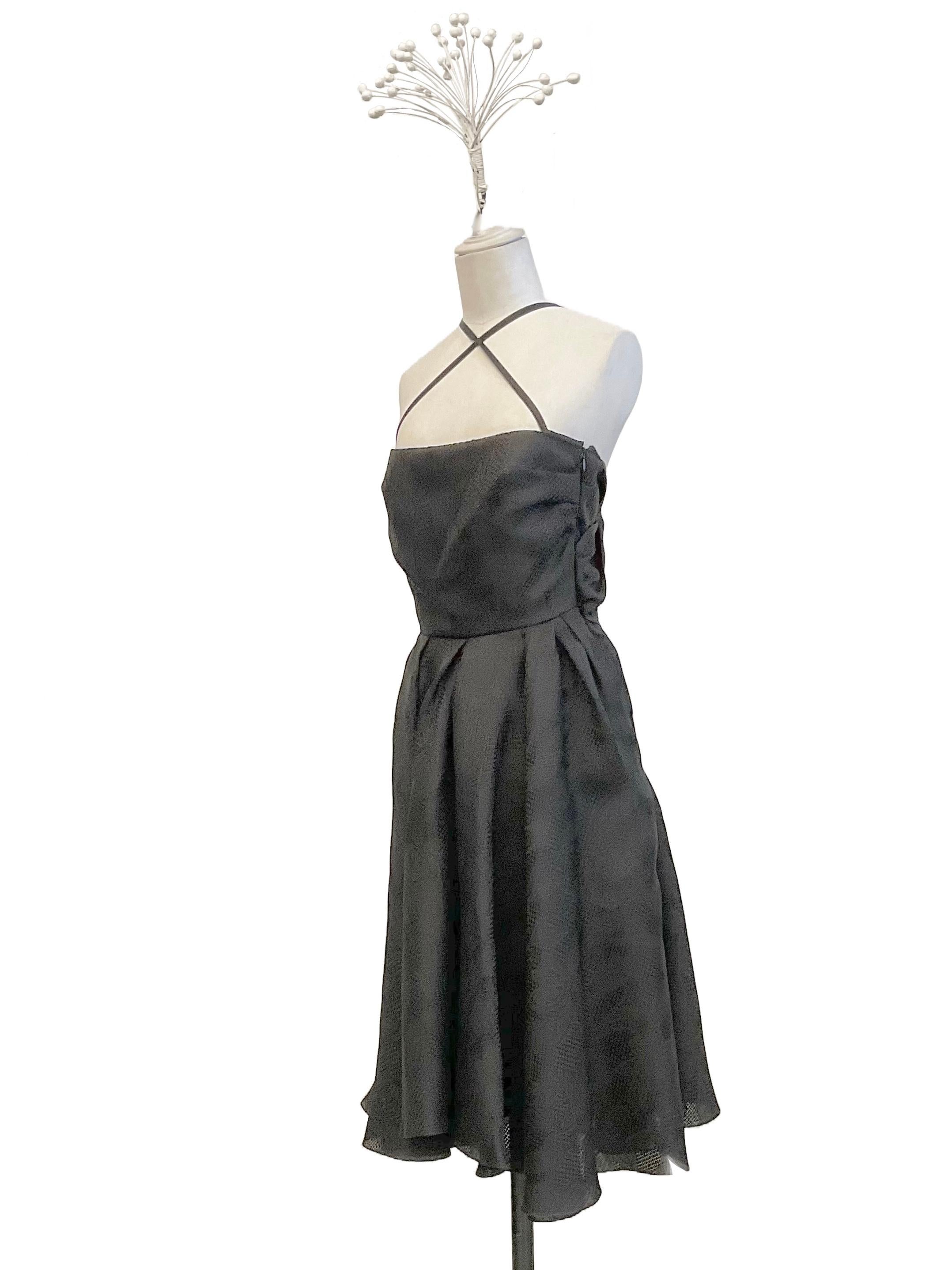 Black cocktail dress by John Galliano from the Ready to Wear Spring Summer 2008 collection. 
The fabric of the dress is a 100% silk jacquard with floral patterns. The model has a bustier neckline with thin satin ribbons crisscrossing at the front