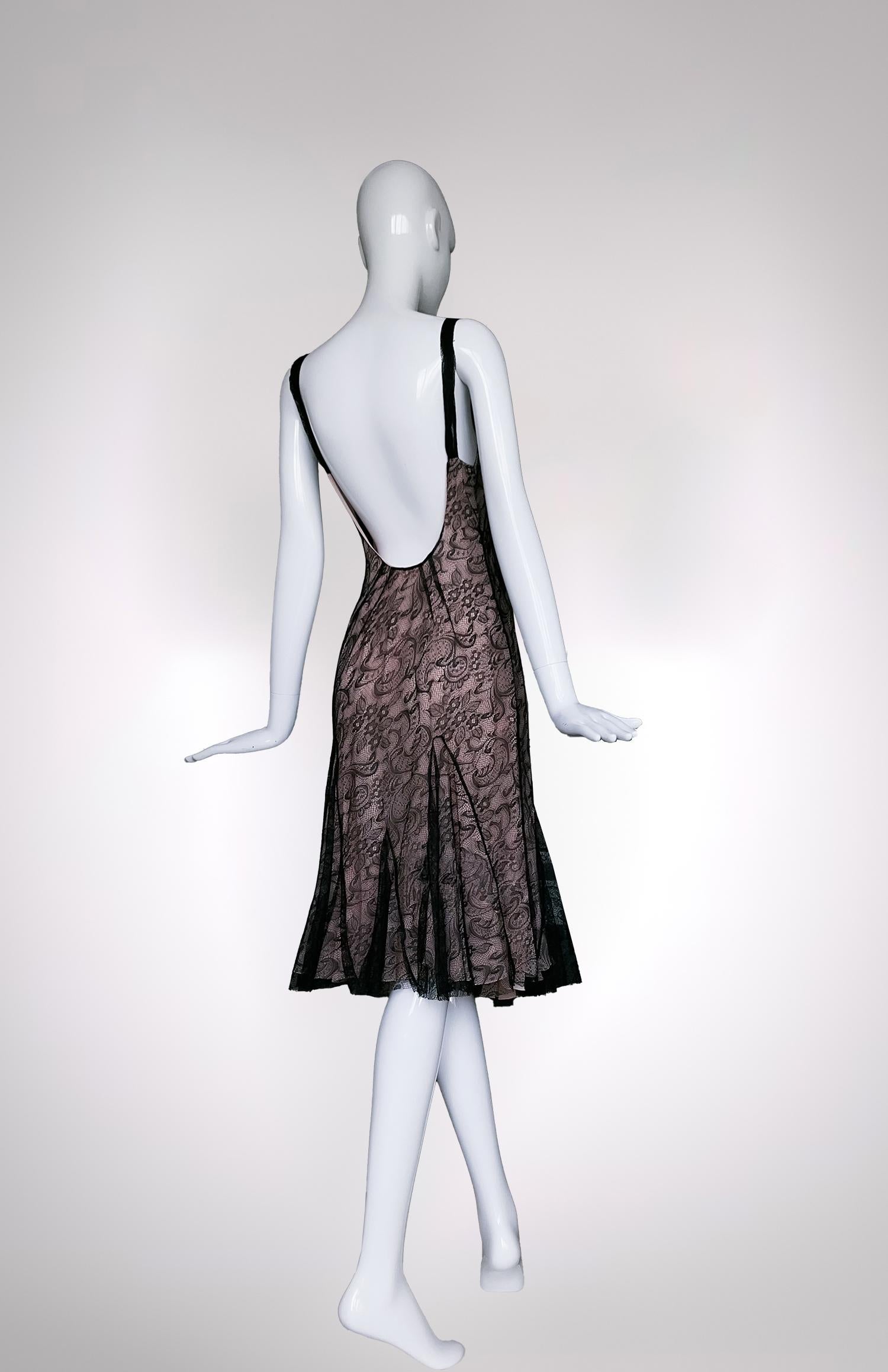 In a seamless blend of timeless elegance and contemporary allure, this 2000s John Galliano dress exemplifies beauty at its finest. Crafted with a meticulous attention to detail, the dress showcases a delicate black lace overlay, which cascades