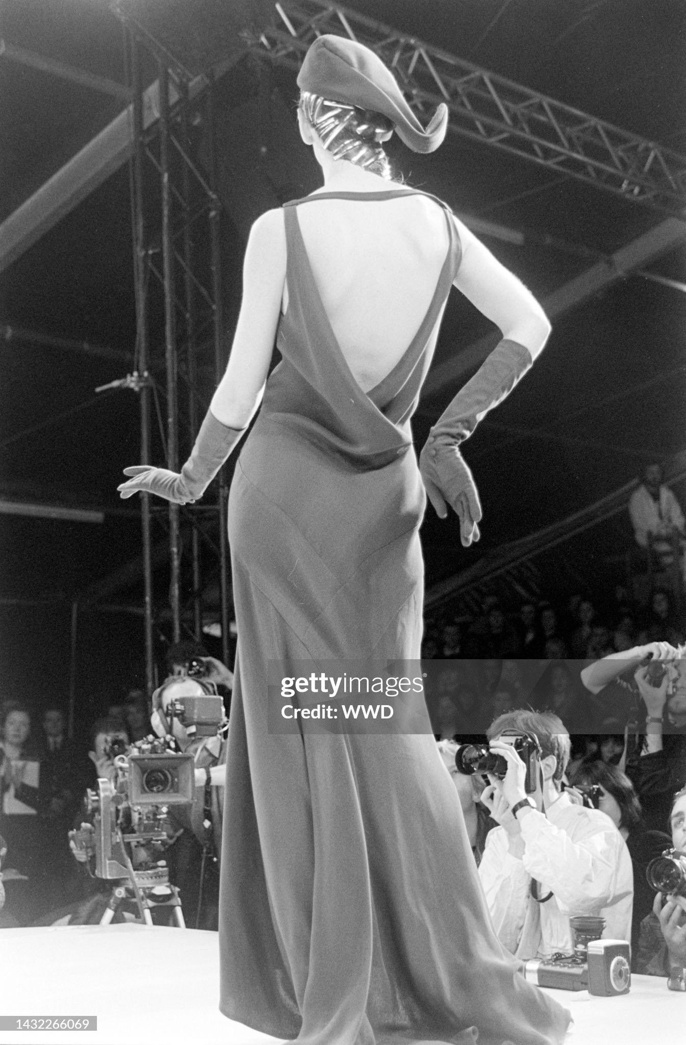 John Galliano Autumn/Winter 1988 ‘Hairclips’ bottle green satin backed viscose crêpe bias cut gown with pointed panels, open cowled back, and flared godet skirt.

This season was the first time Galliano fully introduced 30’s inspired bias cut gowns,