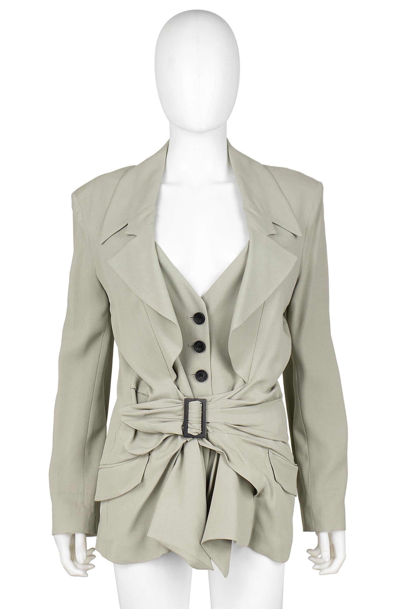 John Galliano blazer 
Beige crepe rayon blend  
Three notch collar 
Pleated waist detail with faux brown belt 
Faux vest design 
Brown button closures 
Brown buttons on the sleeve 
Back vent 
Upper back and sleeves lined in silk 
Made in Italy
