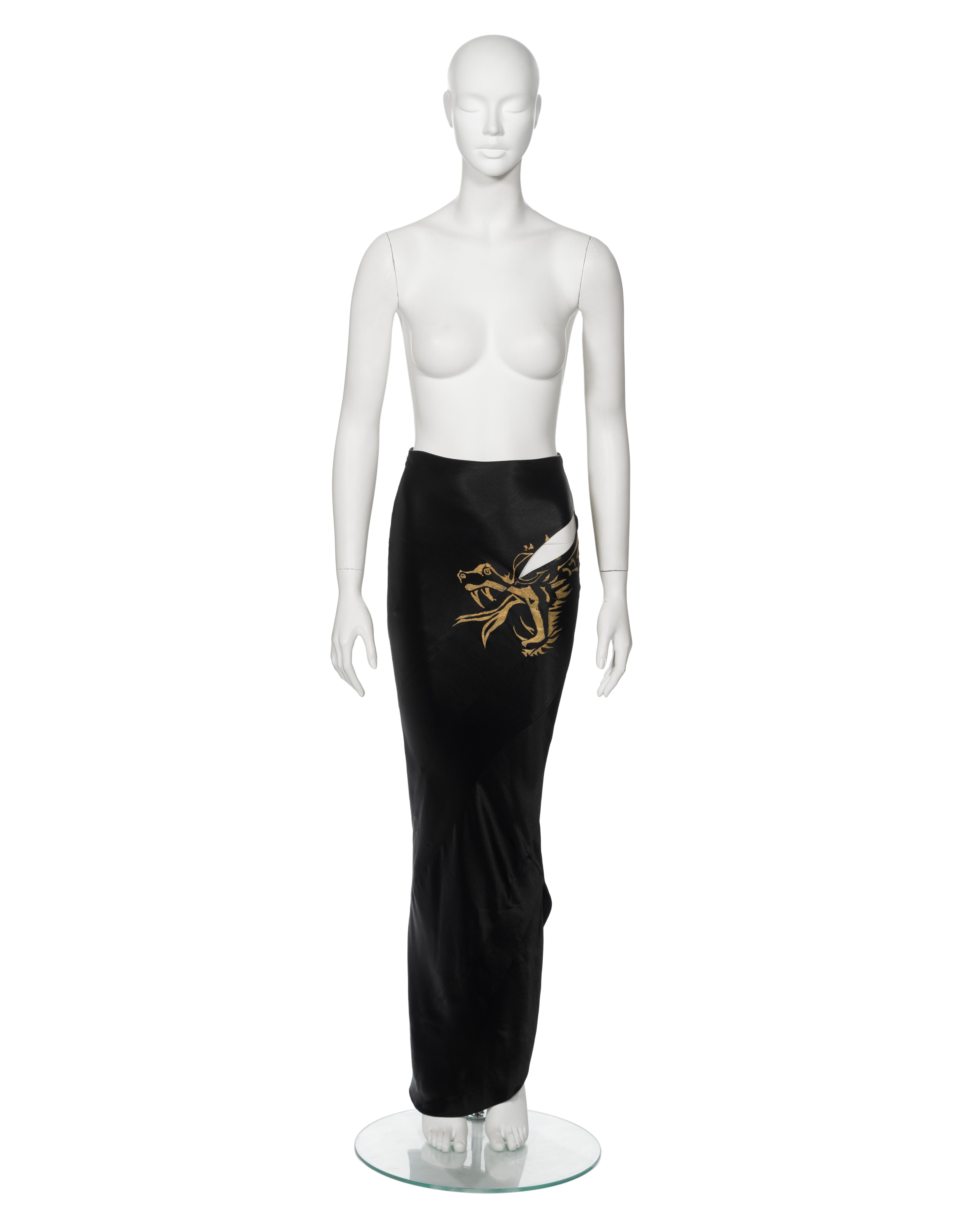 ▪ Archival John Galliano 'Filibustiers' Evening Maxi Skirt
▪ Spring-Summer 1993
▪ Sold by One of a Kind Archive
▪ Museum Grade
▪ Crafted from black bias-cut satin-cuir
▪ Showcases the collection's signature gold leaf dragon motif, originating at the