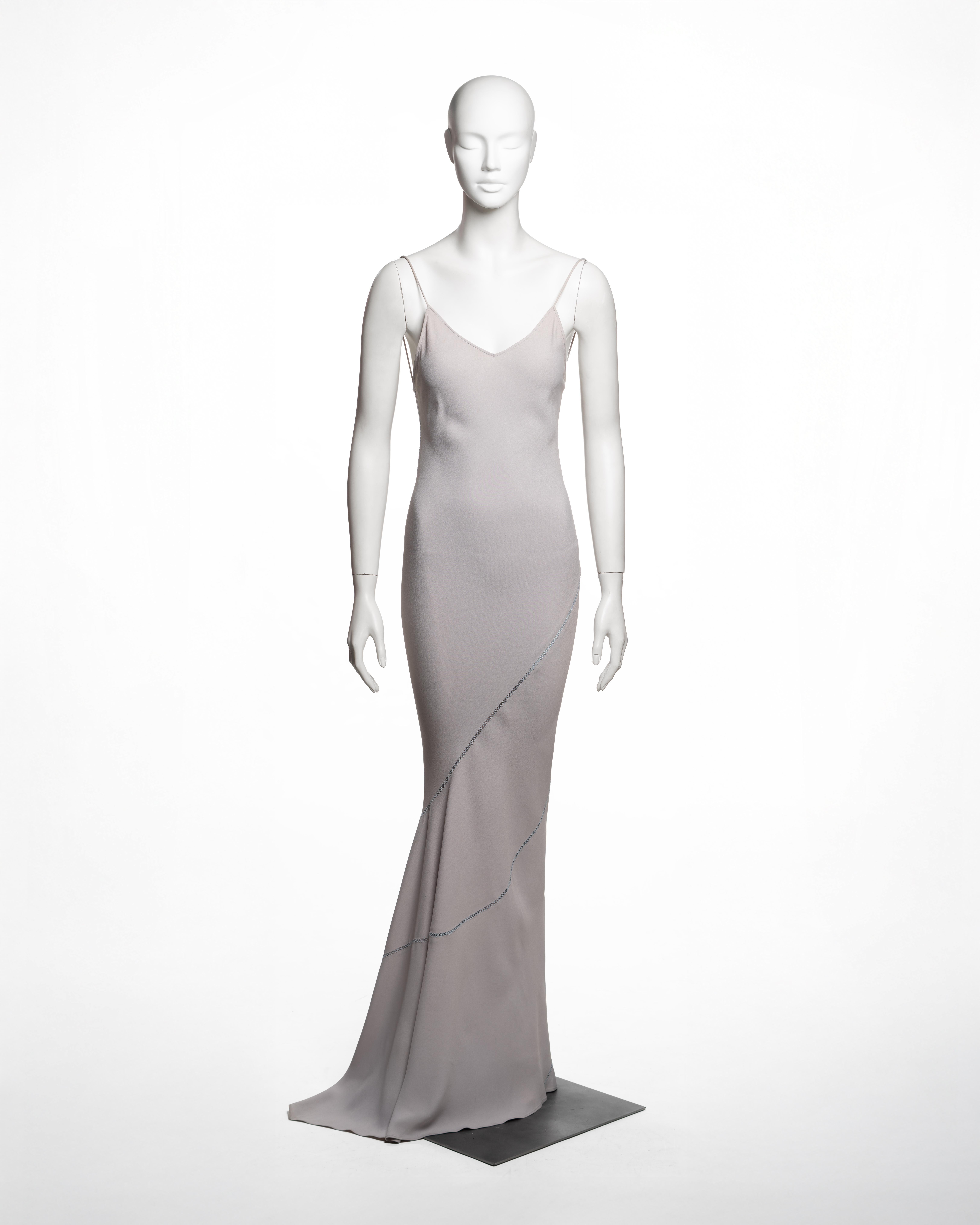 This John Galliano dress from the Spring-Summer 1994 collection demonstrates his signature bias-cut technique, constructed from pale lavender satin-backed crepe. The fitted slip silhouette, defined by slender spaghetti straps and a low scooped back,