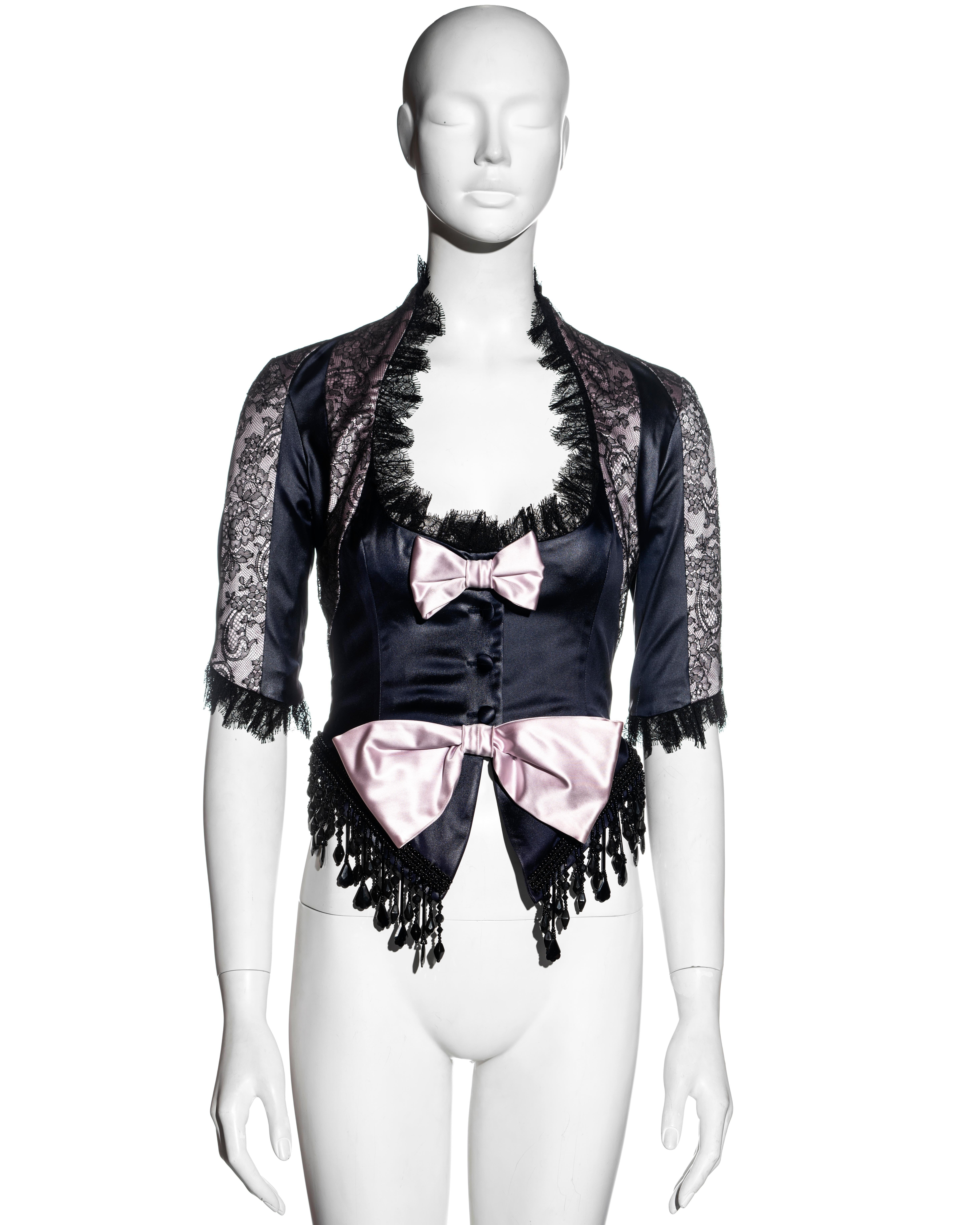 ▪ John Galliano long-sleeve corset 
▪ Black and pink satin acetate 
▪ Black lace trim and overlay to satin panels 
▪ 2 pink bows to the front 
▪ Beaded fringe trim along hemline 
▪ Bias-cut panels to the back panel and sleeves 
▪ 1 black velvet bow