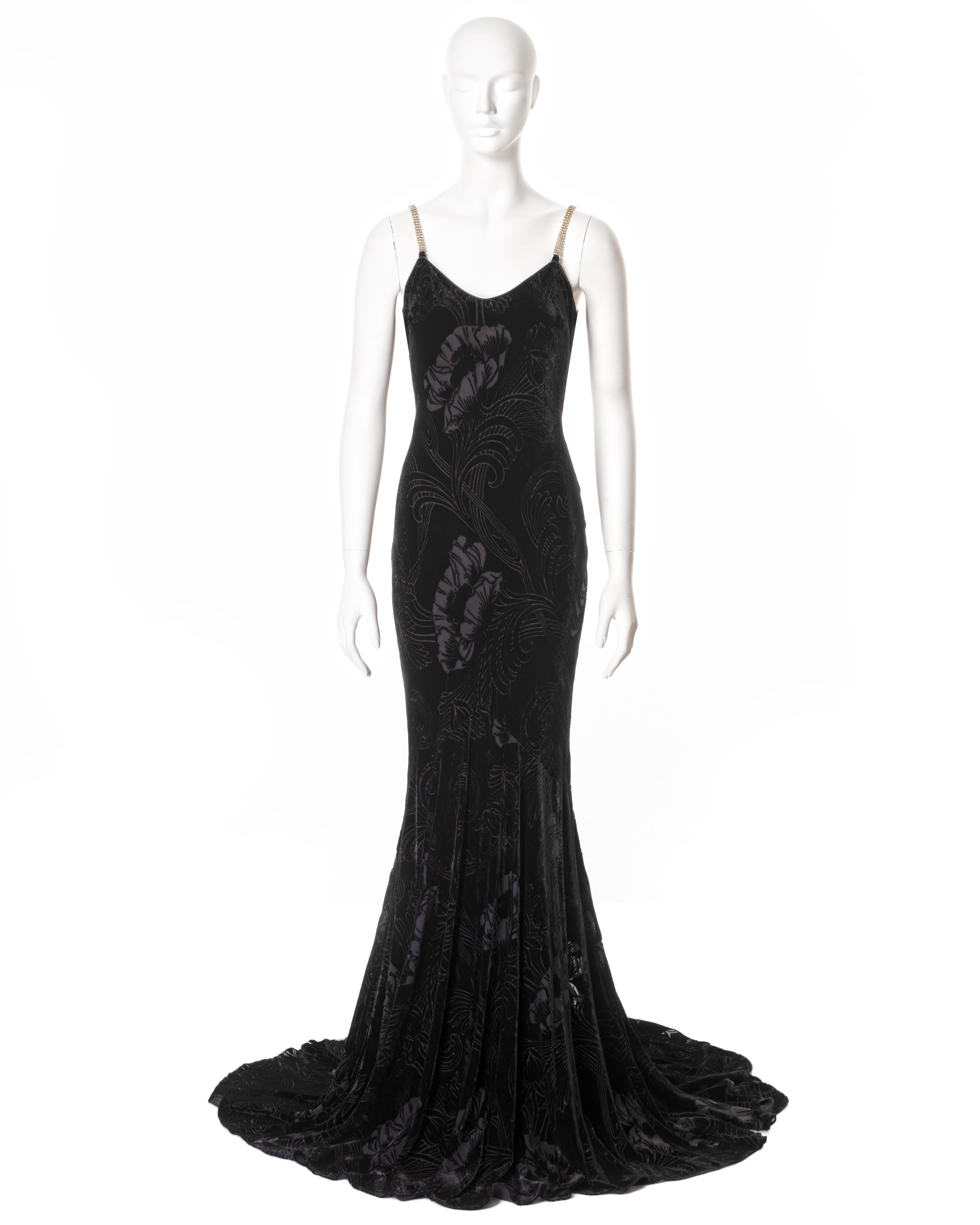 ▪ John Galliano evening dress
▪ Sold by One of a Kind Archive
▪ Spring-Summer 2003
▪ Constructed from bias-cut black cut-velvet with floral motifs 
▪ Crystal shoulder straps 
▪ Floor-length skirt with train
▪ FR 42 - UK 14 - US 8
▪ Made in