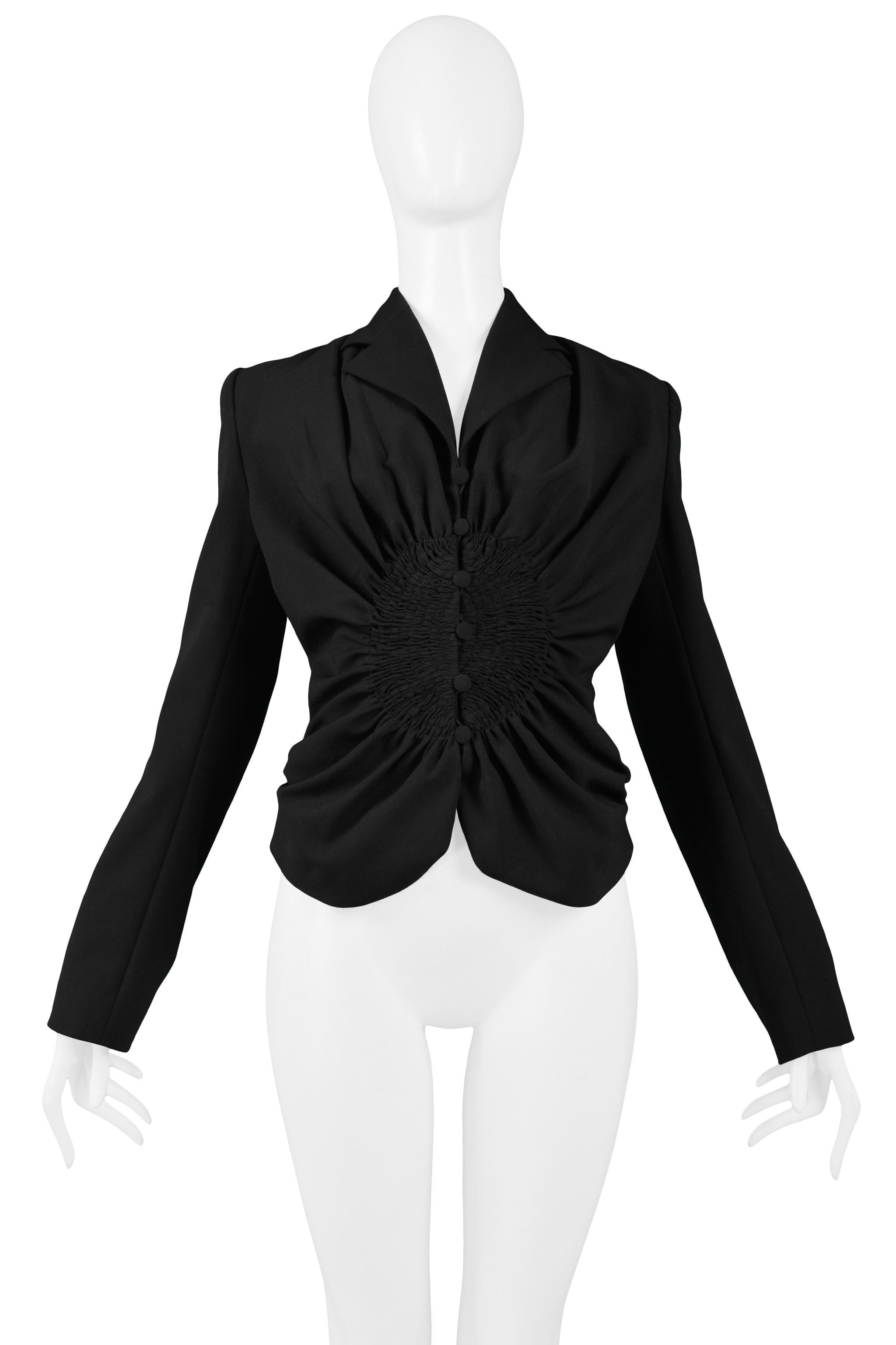 Resurrection Vintage is excited to offer a vintage John Galliano black wool blazer jacket with circular smocking detail at waist, notch-wing collar, fitted body, covered buttons, and center front button closure. 

John Galliano
Size 40
Wool Poly &