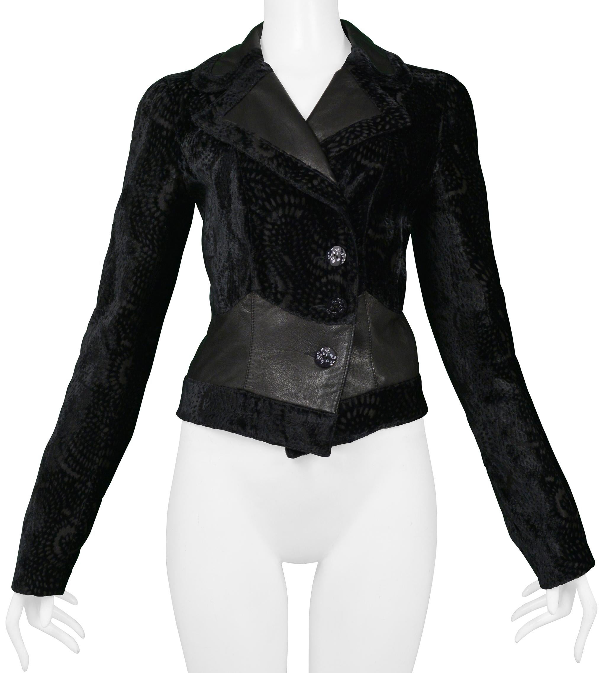 Resurrection Vintage is excited to offer a vintage John Galliano black silk velvet jacket featuring a cut velvet pattern, leather lapels and insets, decorative buttons, and tailored body and three button center front closure.

Companion jacket to