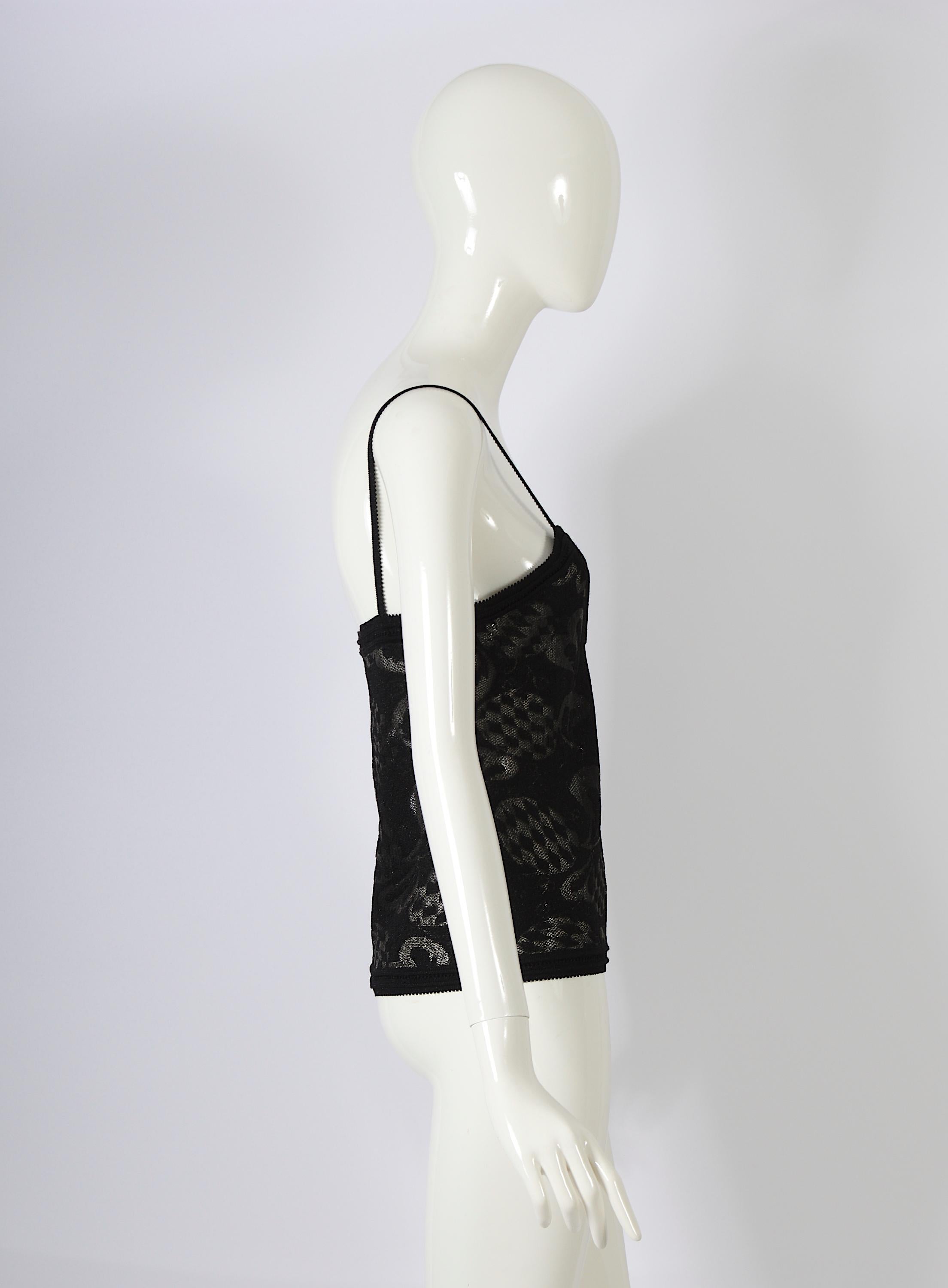This elegant black lurex top embodies the timeless charm of a classic John Galliano design. Featuring spaghetti straps and a flattering fit, it exudes sophistication. The jacquard pattern subtly nods to historical influences, adding a touch of