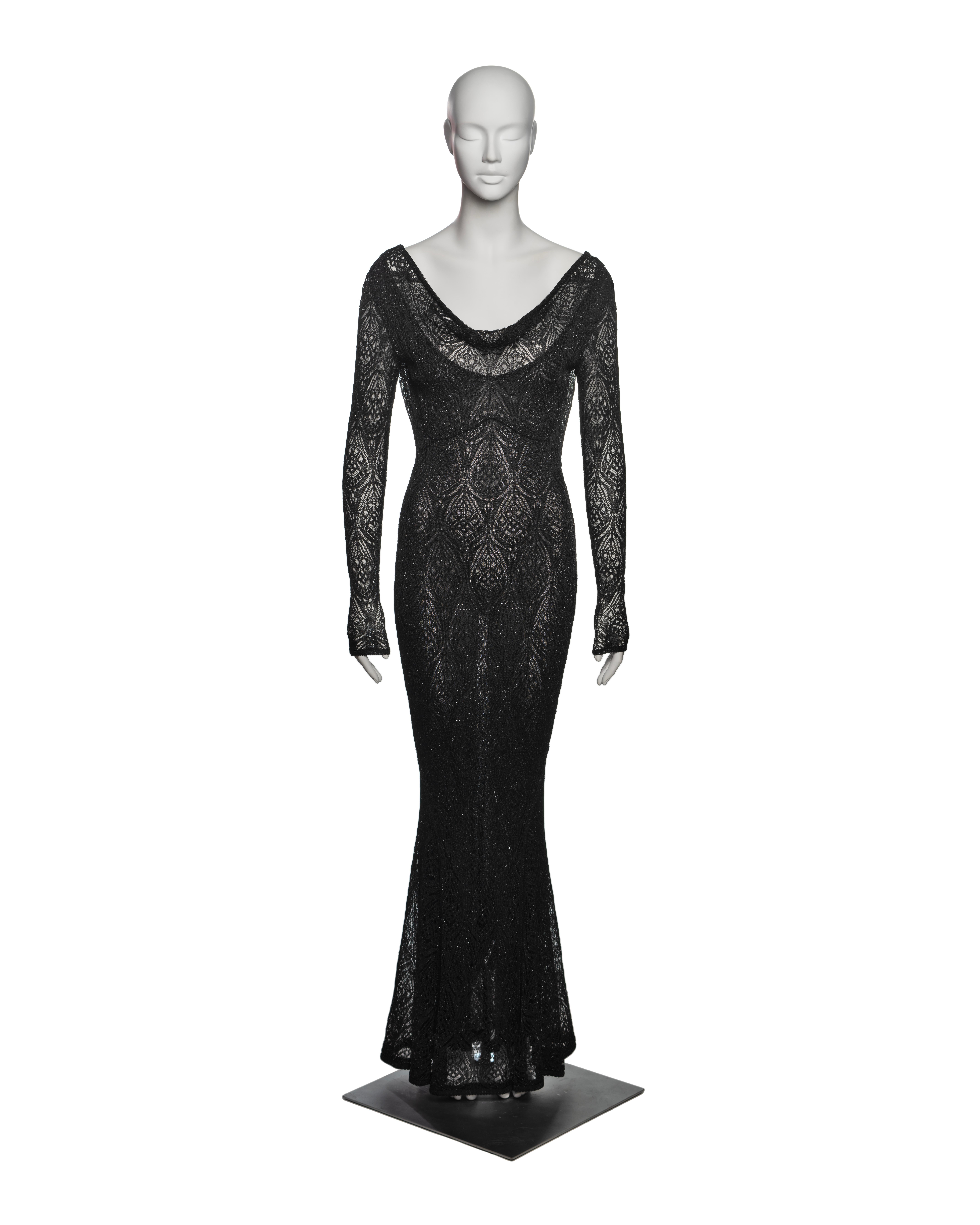 John Galliano black viscose knit lace dress features a figure-hugging silhouette with long sleeves and a floor-length hem. Crafted from intricate knitted lace, the dress showcases a deep scoop neckline and a low draped back.

▪ Brand: John
