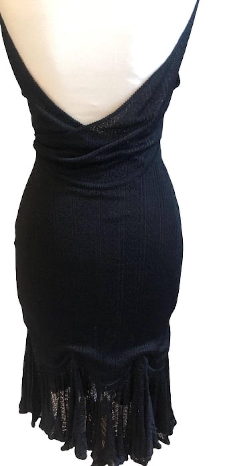 JOHN GALLIANO exquisite sleeveless knitted lace v-neck dress. A rare vintage
Galliano runway couture style. Handcrafted in black perforated lace with flounce hemline. Deep plunging neckline front and open low back behind. Fully lined, closing with a