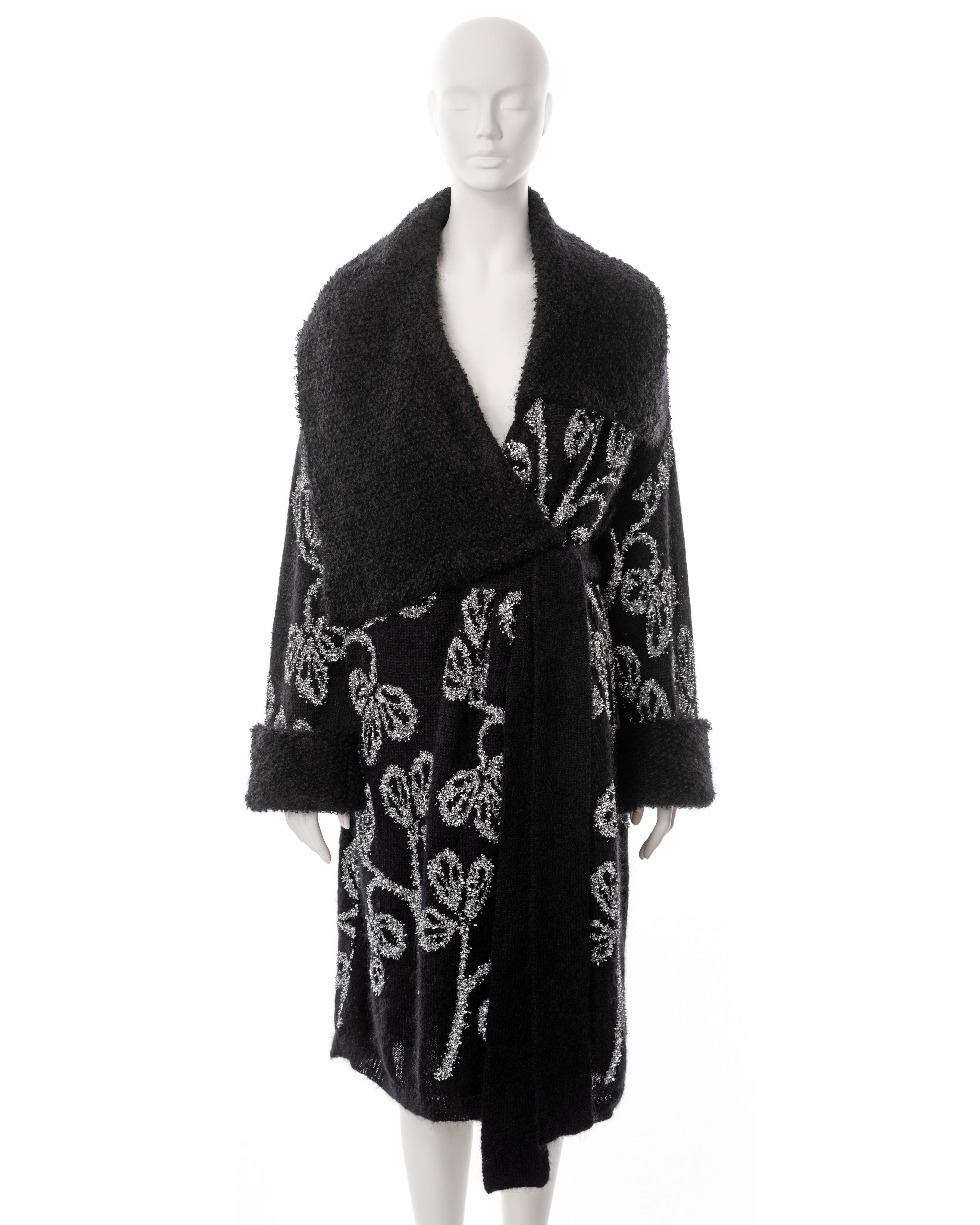 ▪ John Galliano black knitted wool cardigan 
▪ Sold by One of a Kind Archive
▪ Spring-Summer 2003
▪ Silver tinsel embroidery in a floral motif 
▪ Large asymmetric collar 
▪ Self-fabric tie belt 
▪ Loose-fit 
▪ Size: approx. Medium

All photographs