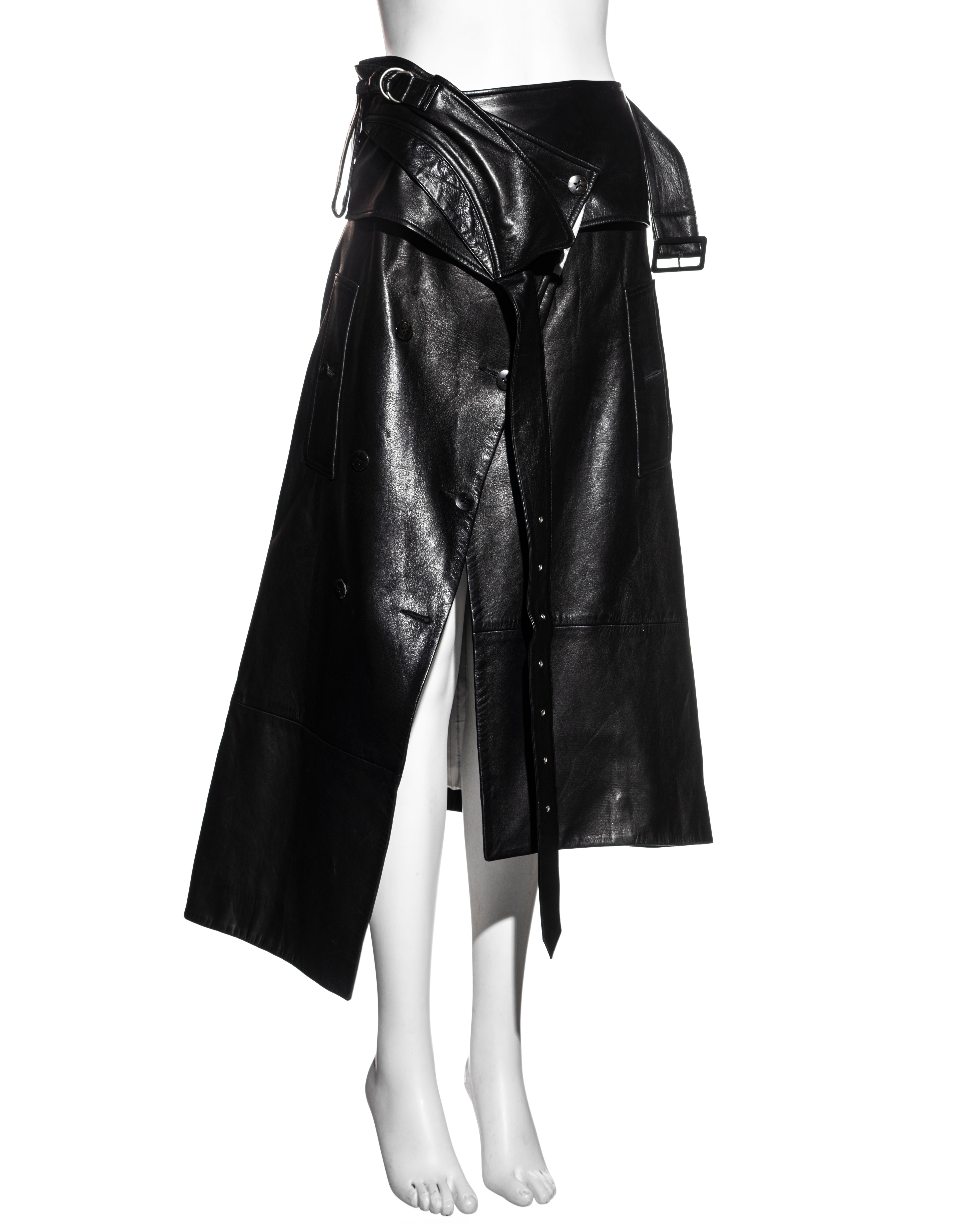 ▪ John Galliano black leather deconstructed wrap skirt 
▪ Silver metal hardware 
▪ Designed to look like a leather coat deconstructed into a skirt
▪ Front button fastenings 
▪ Asymmetric hemline 
▪ FR 38 - UK 10 
▪ c. 2002