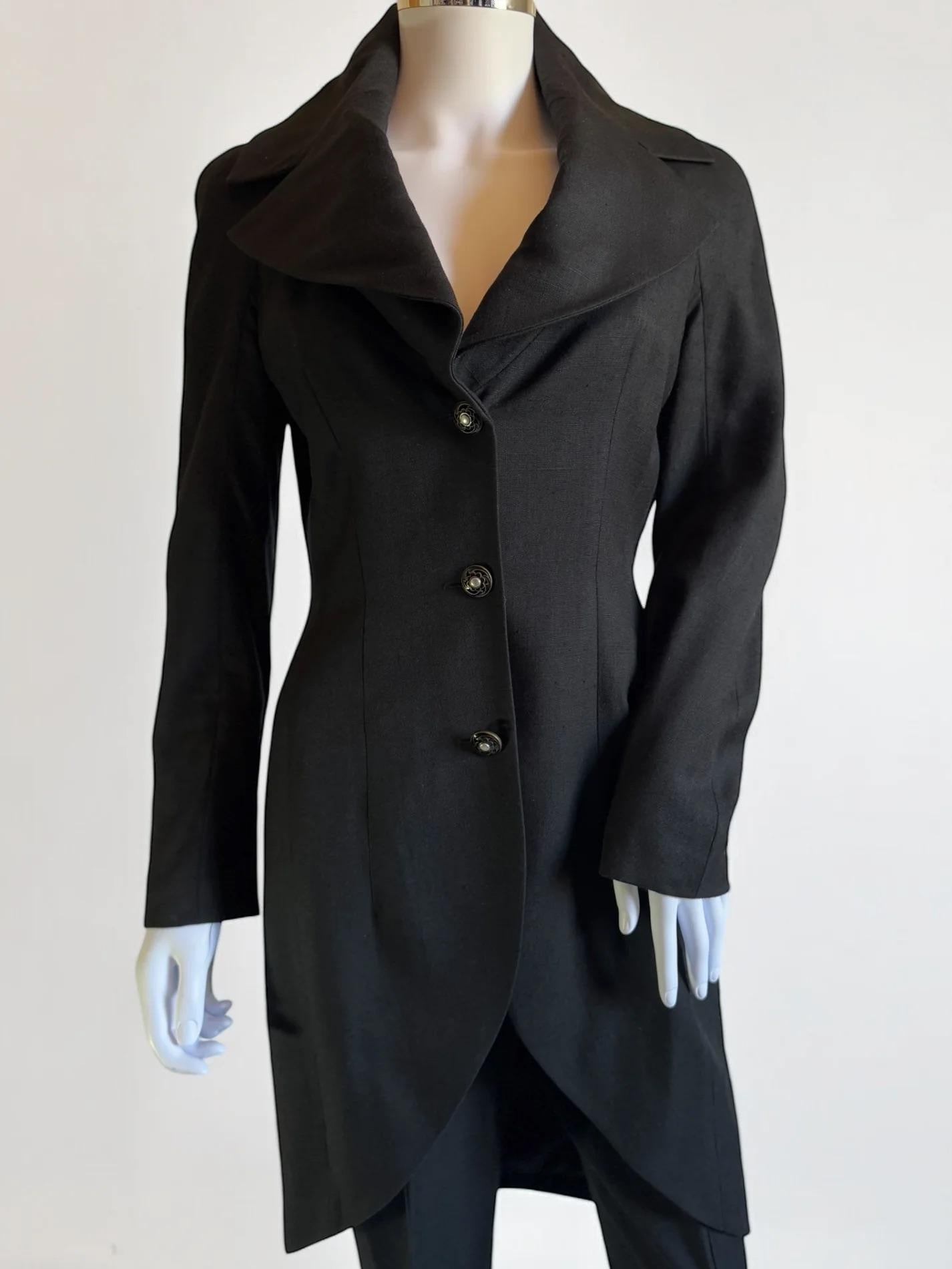 John Galliano black two-piece tailcoat trouser suit, Spring Summer 1998
88% viscose 12% linen
Lining 100% silk
Jacket features gorgeous dramatic lapel with subtle shoulder pads, and the trousers have a clever seam sewn into the hip which continues