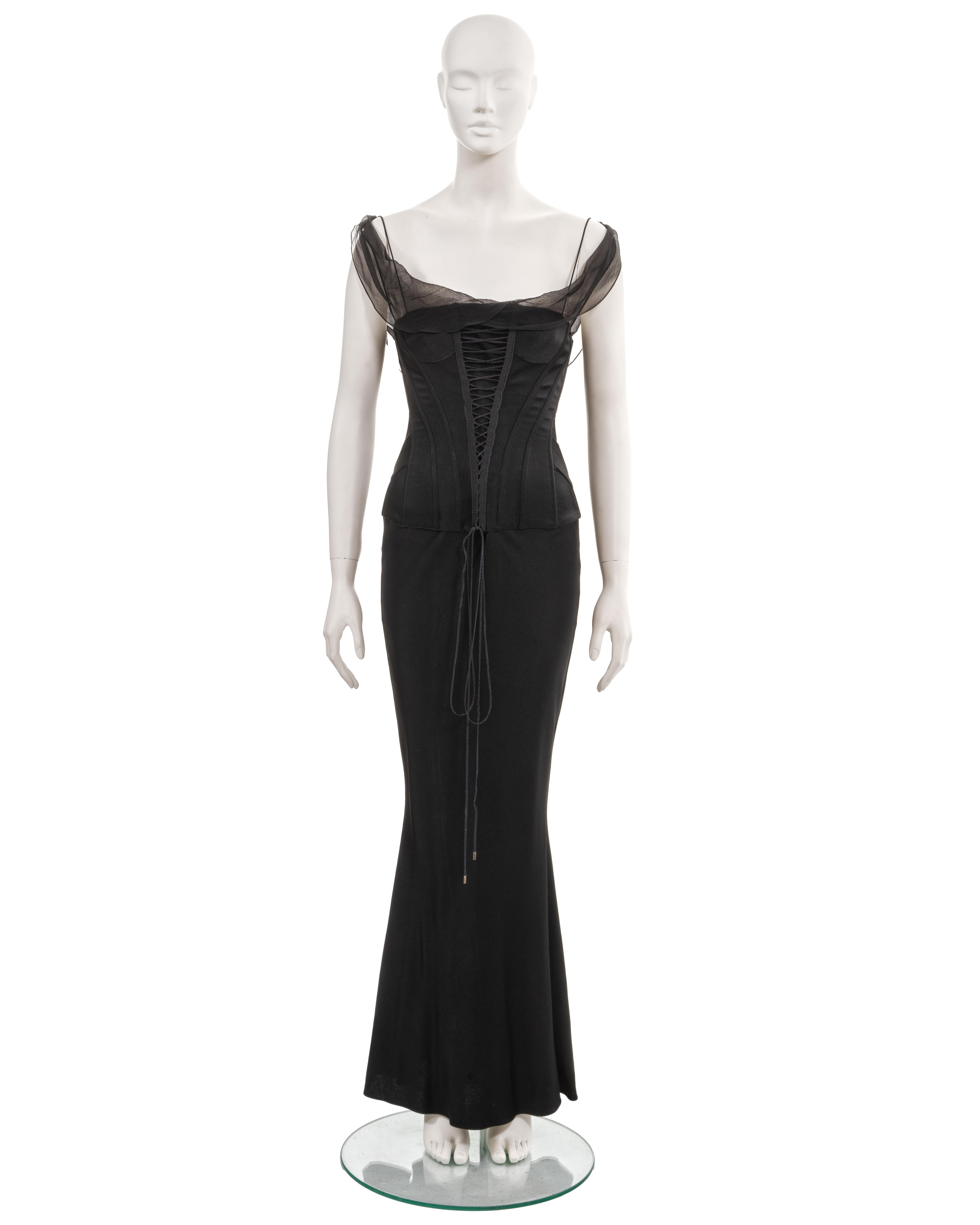 ▪ John Galliano evening dress
▪ Spring-Summer 2003
▪ Sold by One of a Kind Archive
▪ Black bias-cut crepe-backed-satin 
▪ Integrated corset with lace-up fastenings at the front and back
▪ Silk chiffon cowl neck and off-shoulder straps
▪ Floor-length