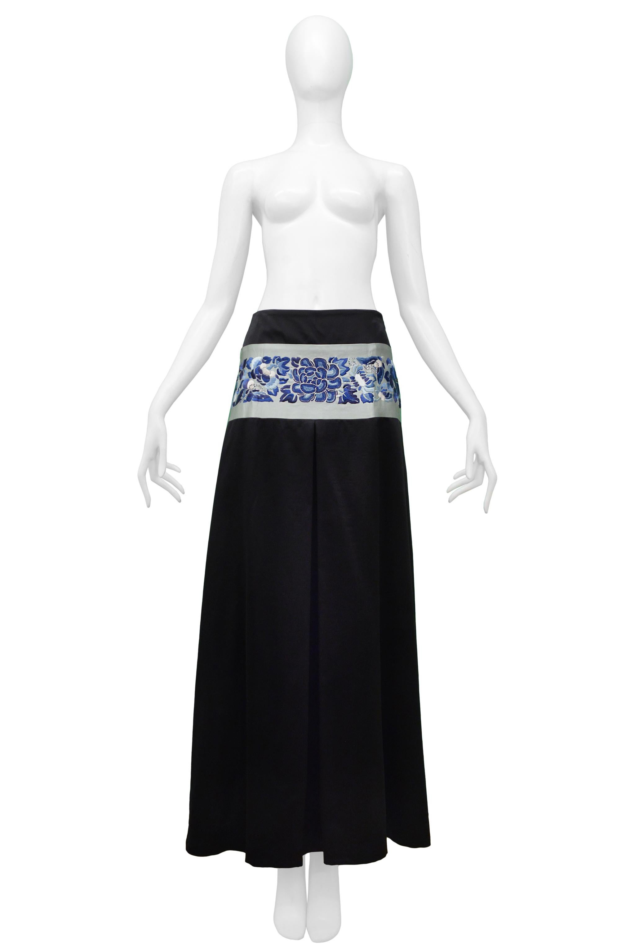 Resurrection Vintage is pleased to offer a vintage John Galliano black satin maxi skirt featuring large pleats and a blue floral Asian-inspired embroidered waistband.

John Galliano 
Size 6 or F40
Wool And Silk 
Excellent Vintage Condition