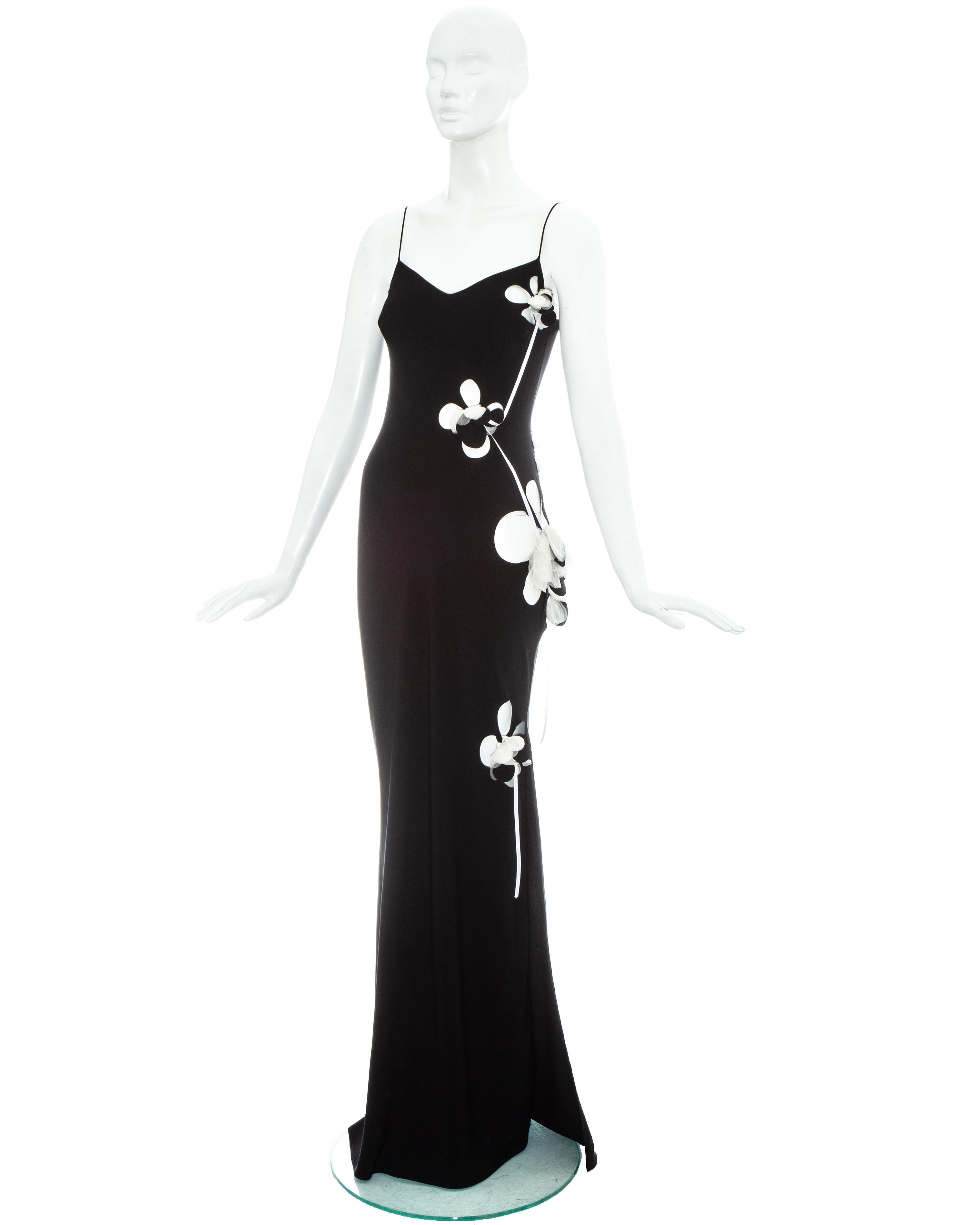 John Galliano black silk evening maxi dress with floral shaped cut outs throughout, floral motifs and white ribbon. Comes with detachable optional white lining.

Fall-Winter 2001
