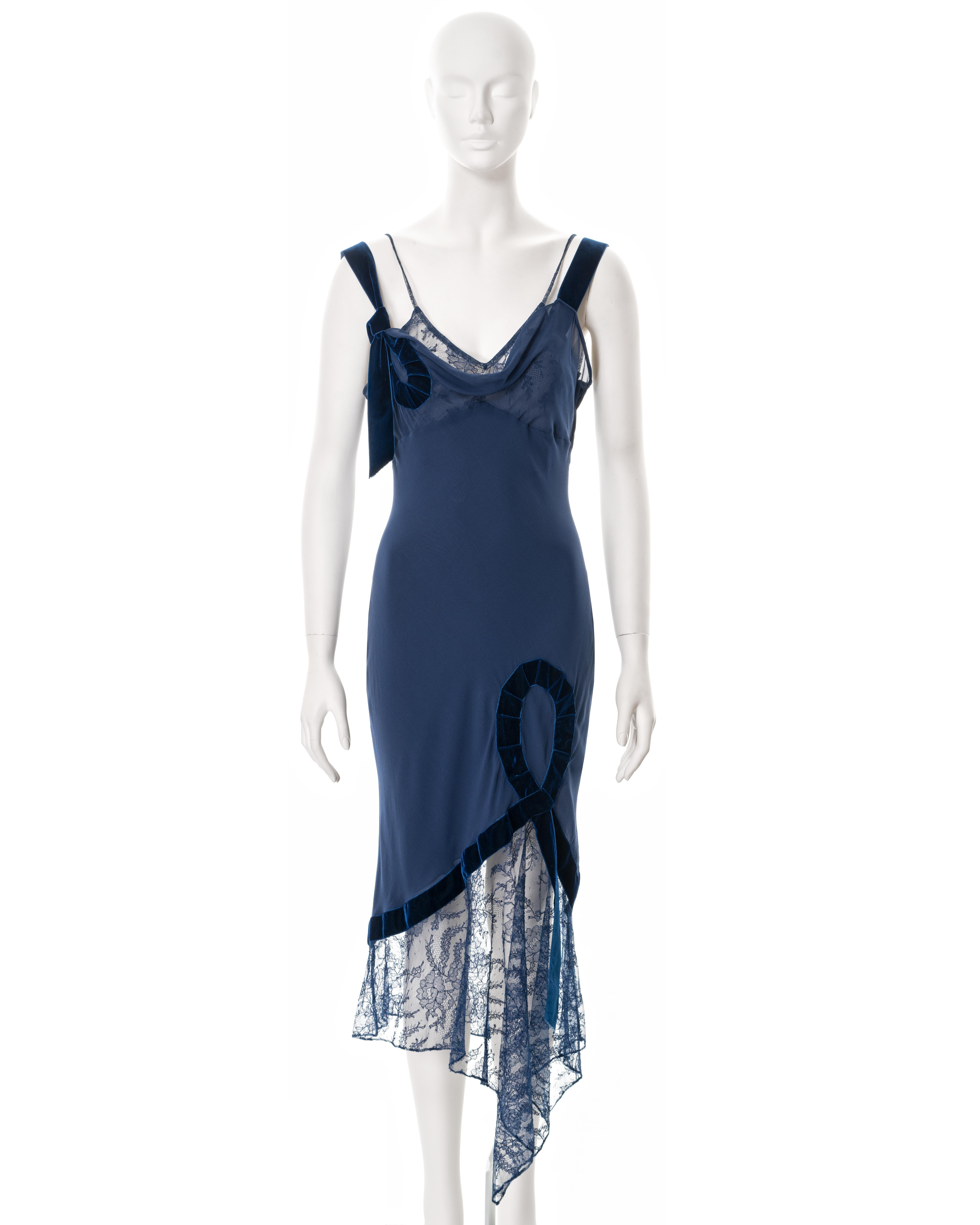 ▪ John Galliano evening dress
▪ Sold by One of a Kind Archive
▪ Fall-Winter 2001
▪ Constructed from blue bias-cut silk 
▪ Blue lace underlay and skirt 
▪ Cowl neckline 
▪ Velvet ribbon trim and shoulder straps 
▪ Size FR 40 - UK 12 - US 6
▪ Made in
