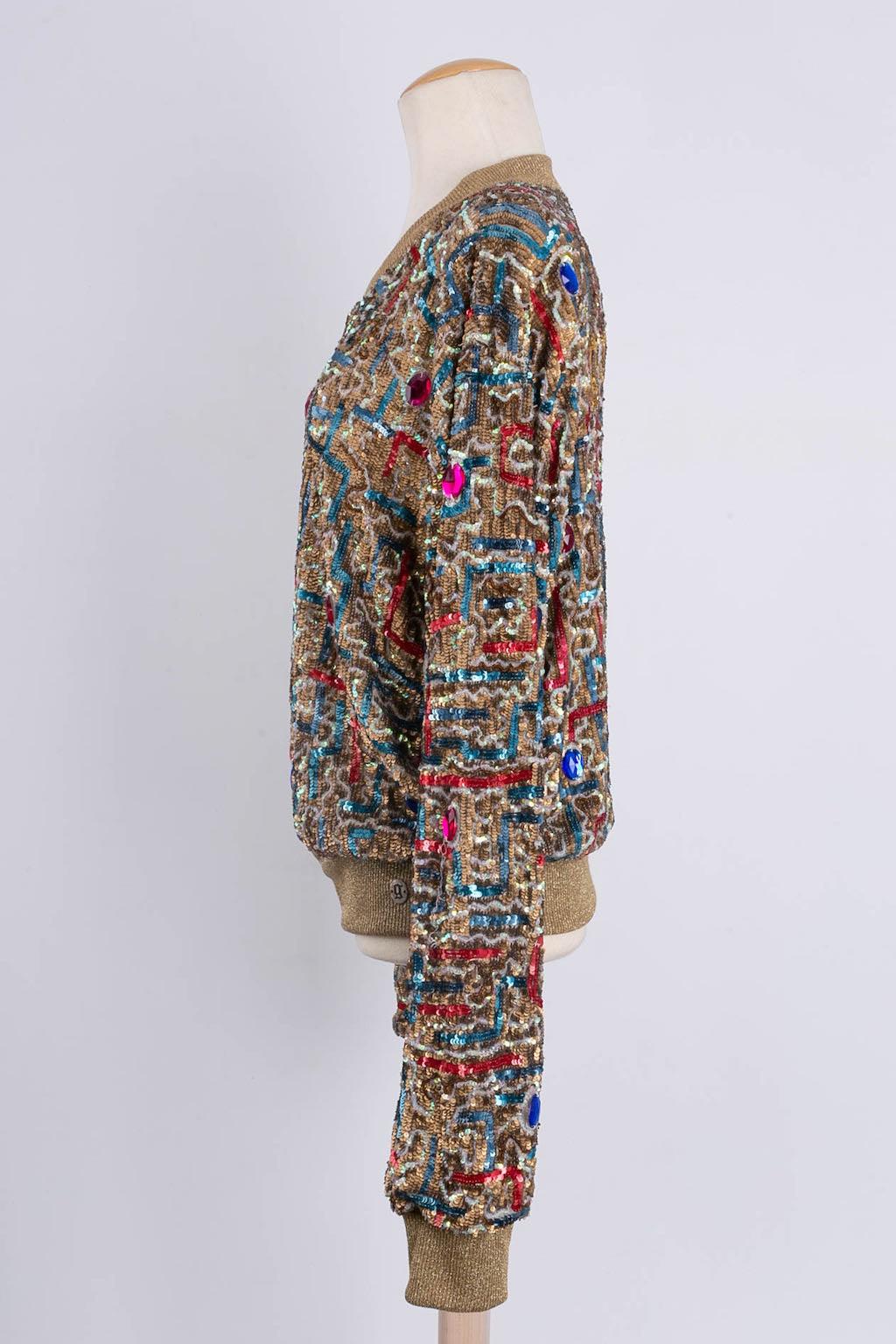 John Galliano (Made in India) Bombers-style jacket composed of tulle embroidered with sequins. Size 38FR.

Additional information: 
Dimensions: Shoulders: 54 cm (21.25