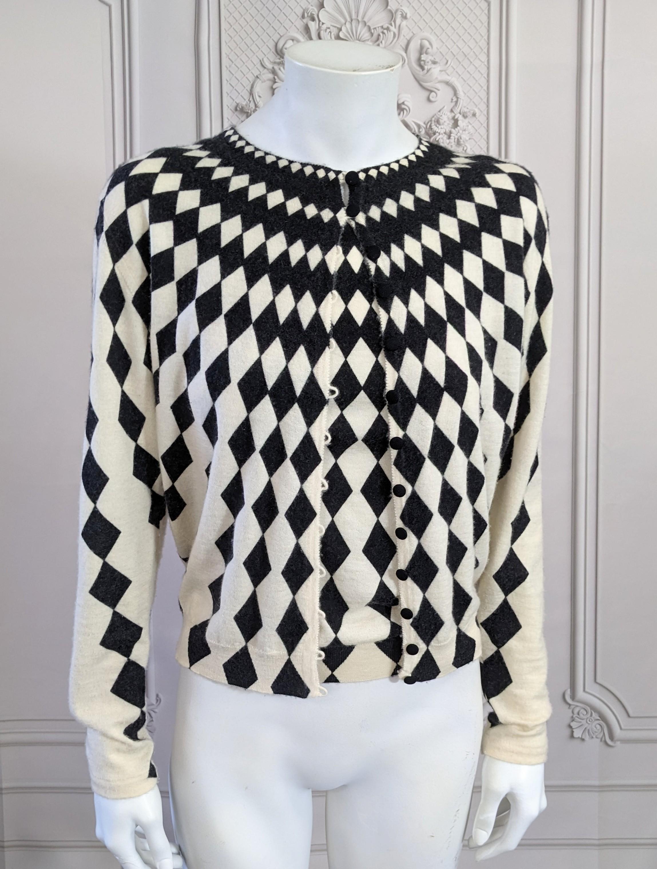 John Galliano Harlequin twin set from Spring Summer 2000 of light weight ivory cashmere printed in a black Escher diamond pattern. Camisole and cardigan set.
Excellent Condition. Size Medium but fits Mannequin size 2. 