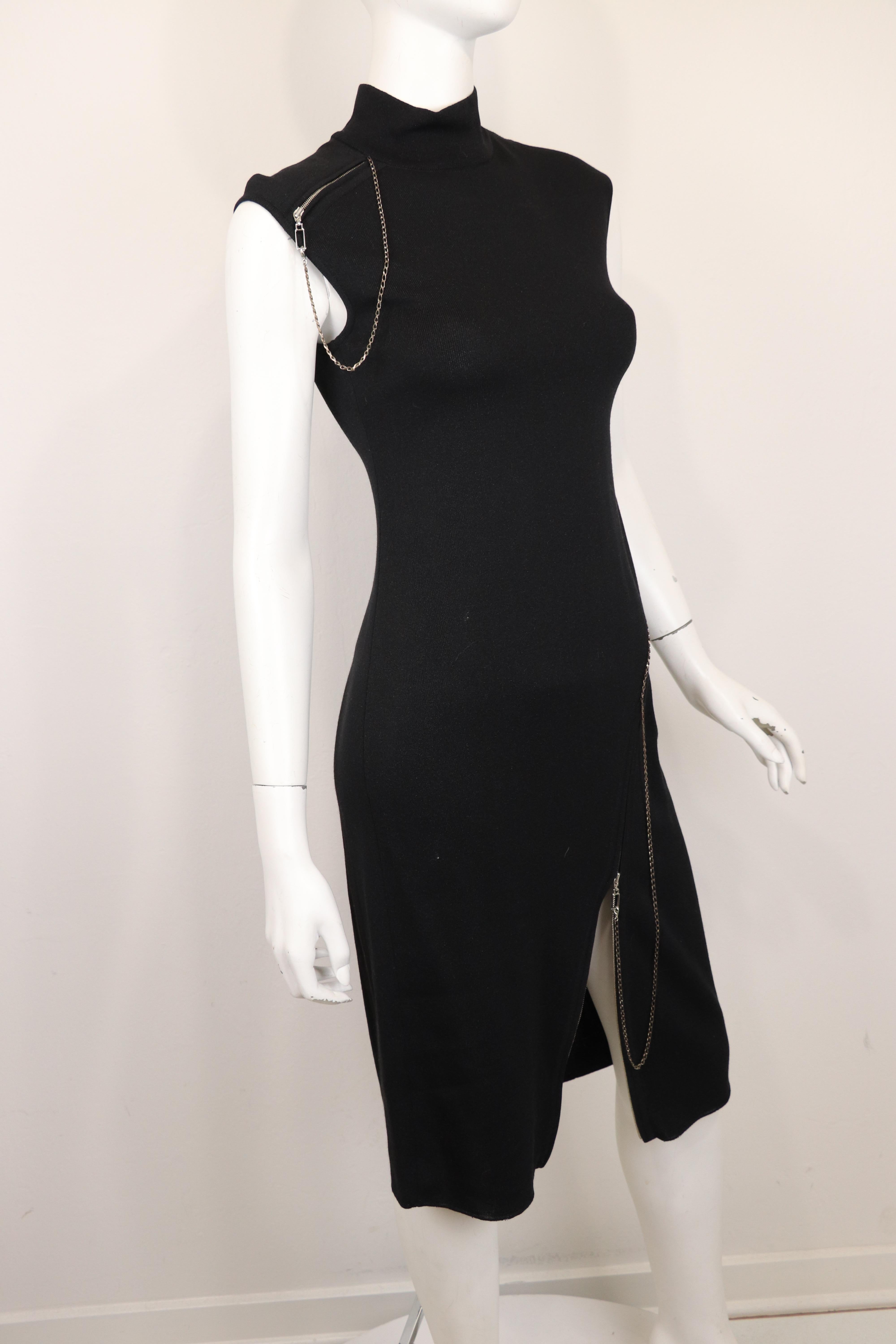 Bodycon dress by the notorious John Galliano, known for his avant- guard pieces, showcases a black knit sleeveless dress with zipper details at the left hip that extends to the right hemline, moving diagonally as a working zipper to expose the