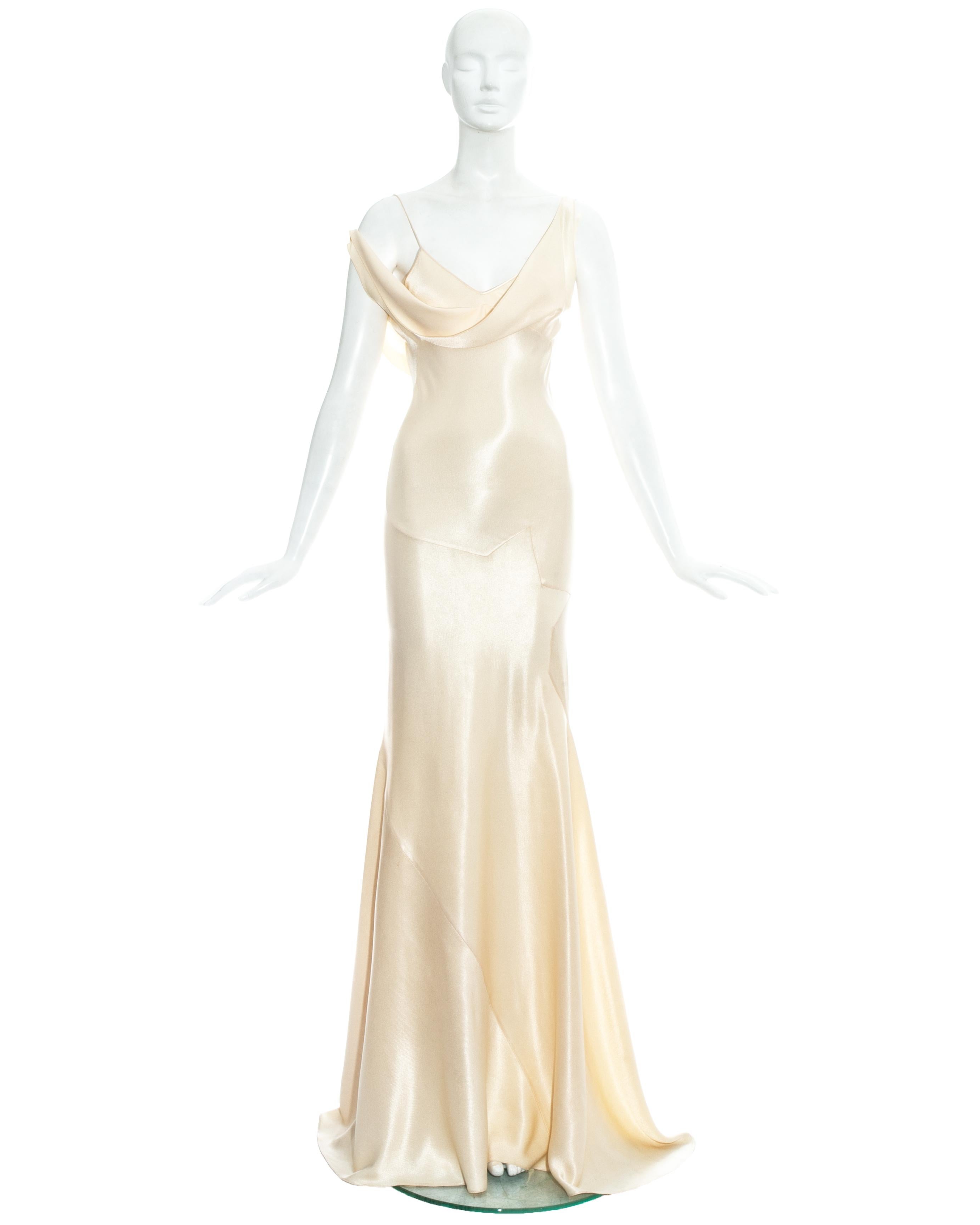 John Galliano; champagne rayon bias cut wedding dress. 

- Spaghetti straps 
- Draped cleavage with one strap designed shorter to be worn off the shoulder 
- Signature Galliano half-star shaped panels around hips 
- Bias cut panels cut to contour