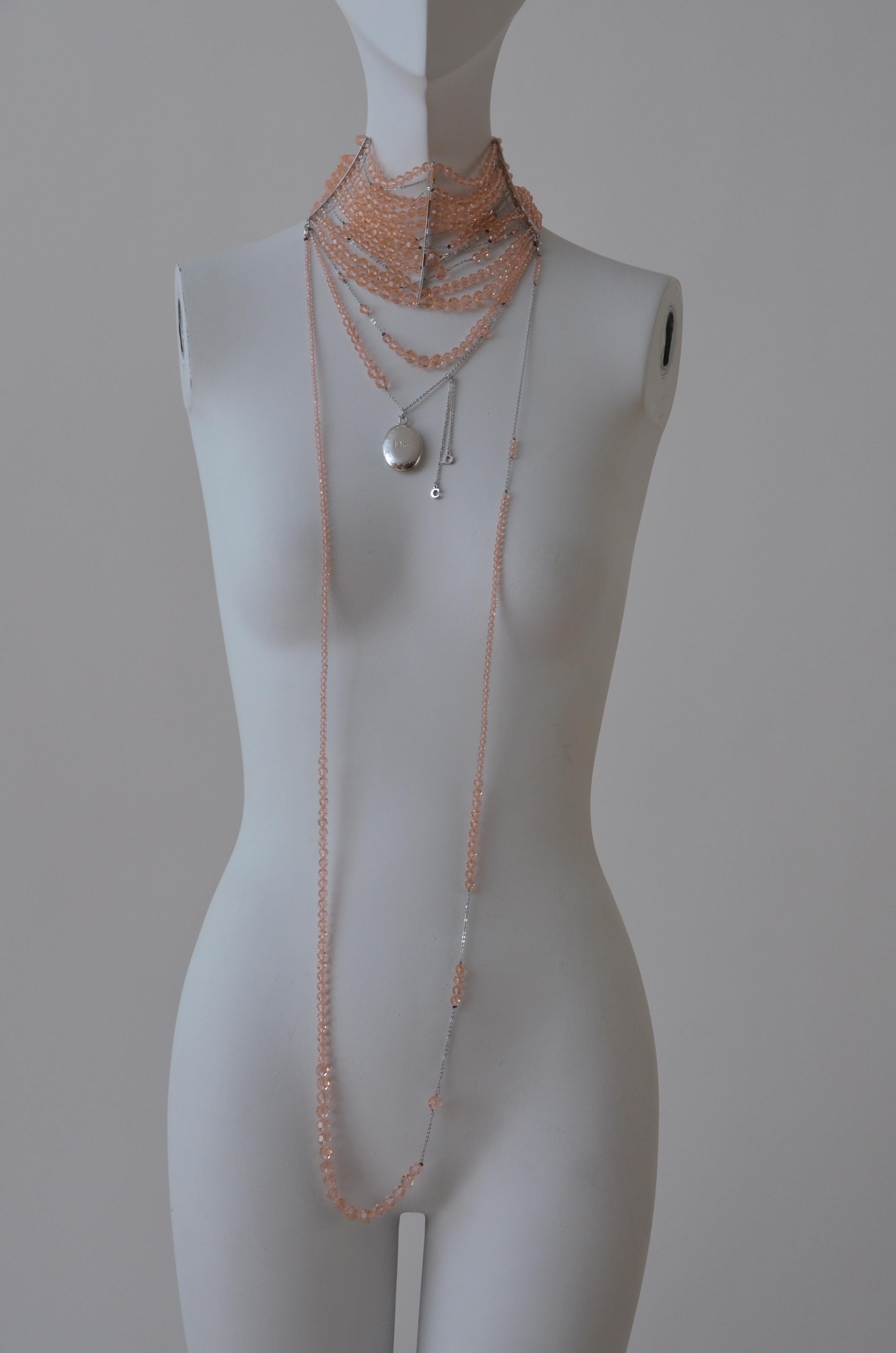 Amazing and rare  Christian DIOR John Galliano Masai Huge Pi color necklace/choker with rows of glass/crystals beads in pink peach color.
Silver tone locket  and C D charms hanging.
Two hooks closure in the back with D charms aded for tight