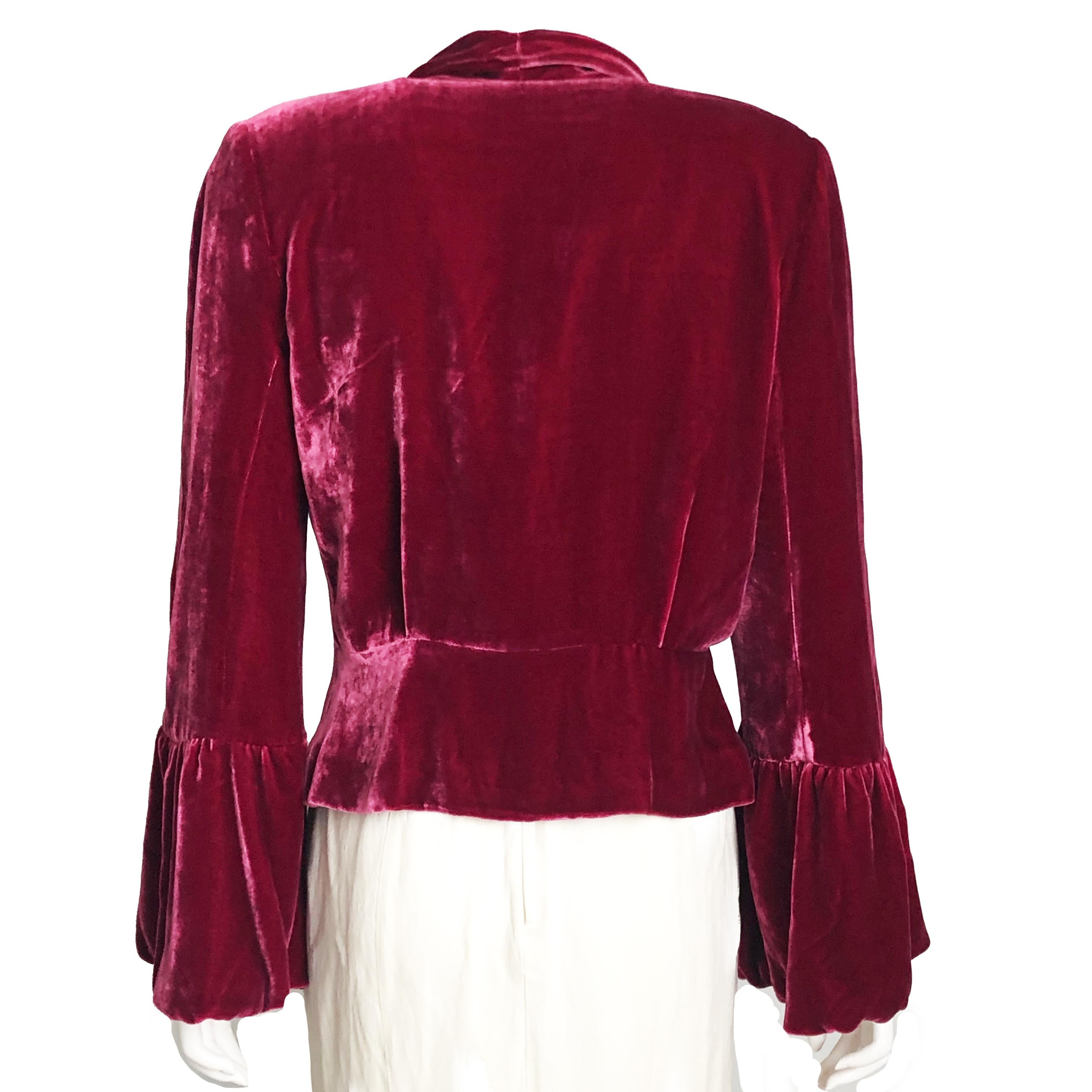 Chic John Galliano Silk Velvet Jacket with peplum hem and bell sleeves, size 10. Made from a silk blend velvet in a rich cranberry red (dark pink hued tone), it's fully lined in matching silk. Dry clean only. Preowned with some signs of prior use &