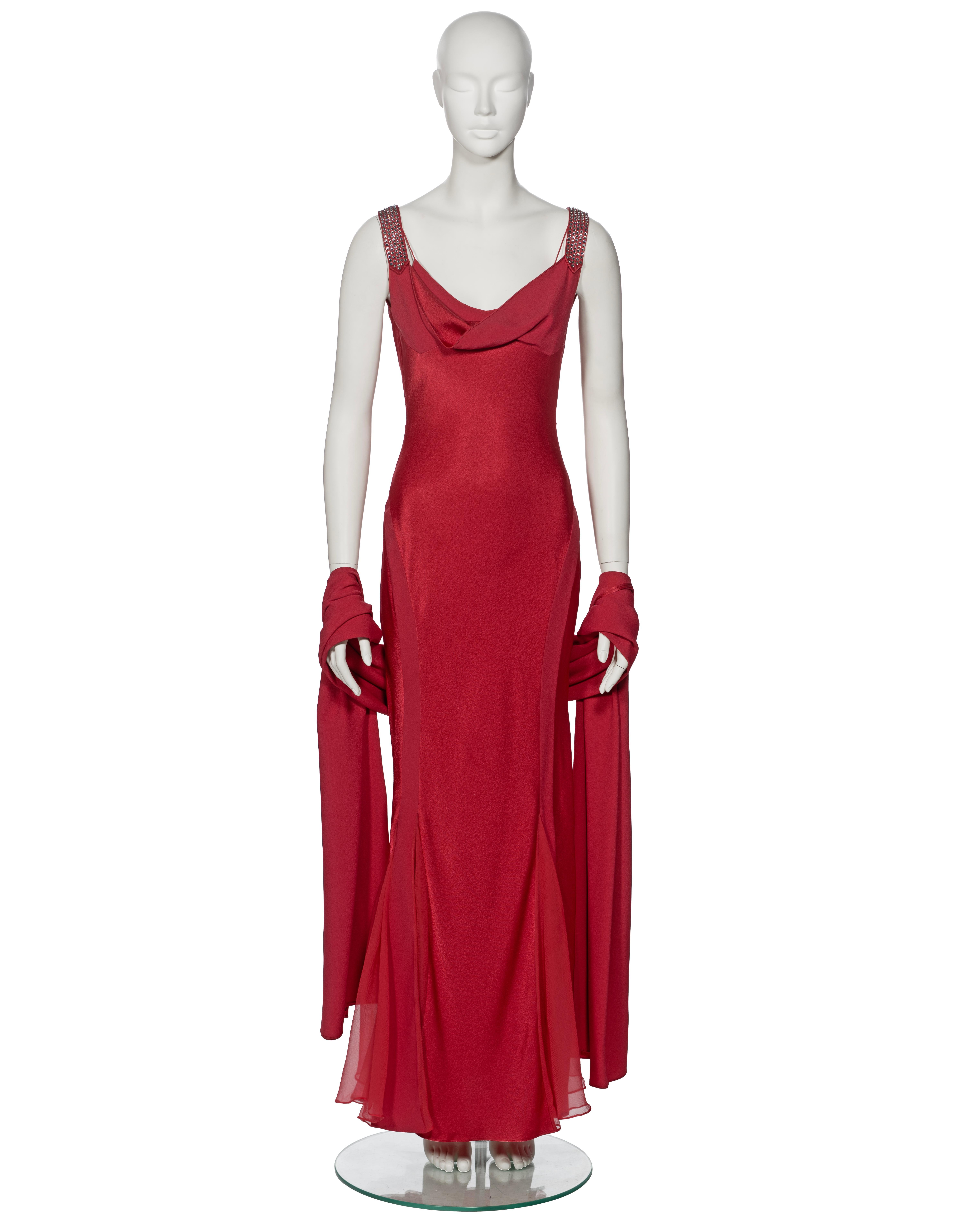 ▪ Archival John Galliano Evening Dress
▪ Spring-Summer 2001
▪ Sold by One of a Kind Archive
▪ Crafted from crimson crepe-back satin, with alternating panels that highlight both the satin sheen and crepe texture
▪ Draped cowl neckline
▪ Double