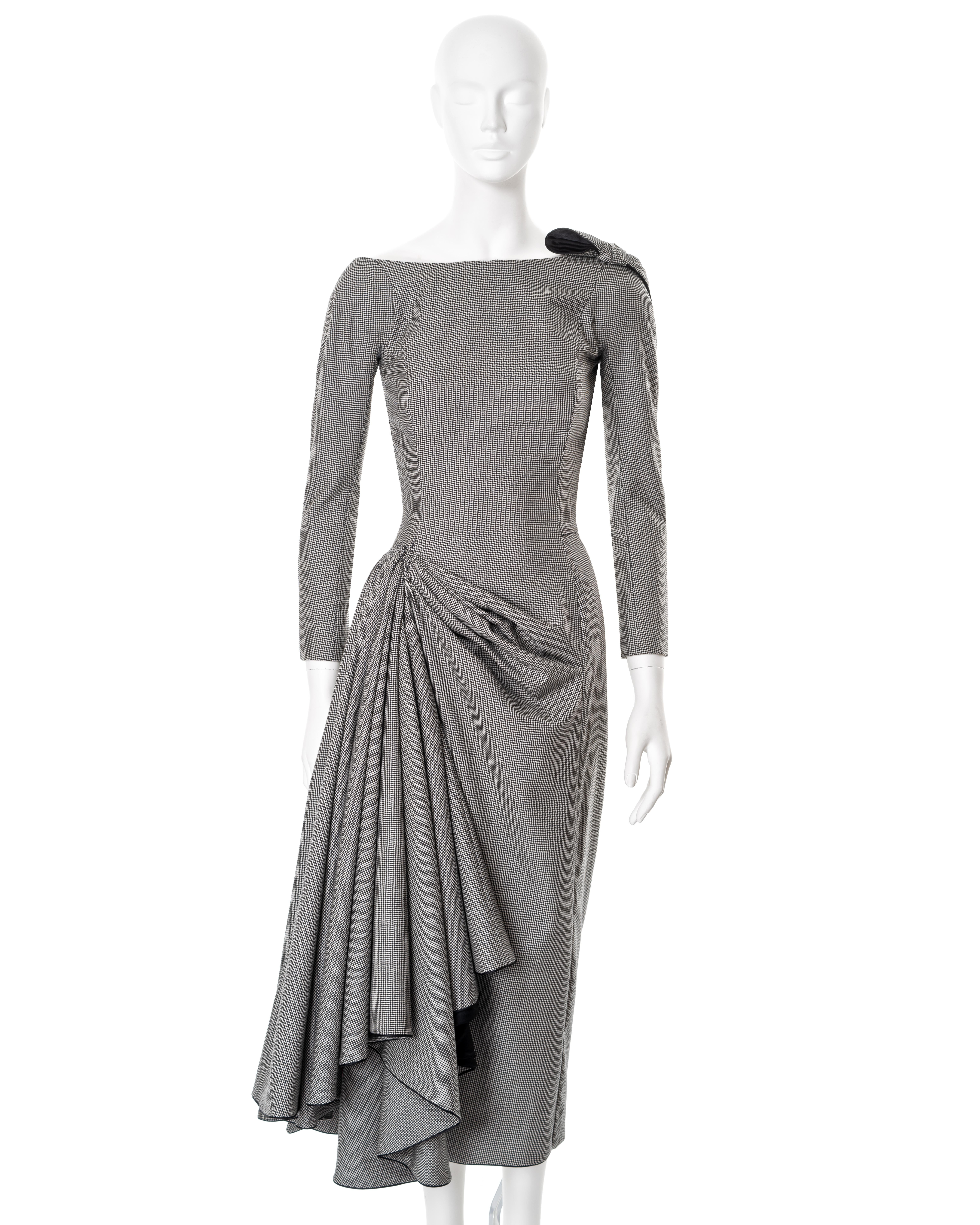 ▪ John Galliano draped wool cocktail dress
▪ Sold by One of a Kind Archive
▪ “Pin-up/ Misia Sert”, Spring-Summer 1995
▪ Museum grade
▪ Constructed from black and white houndstooth check wool 
▪ Calf-length pencil skirt with asymmetric drape to the