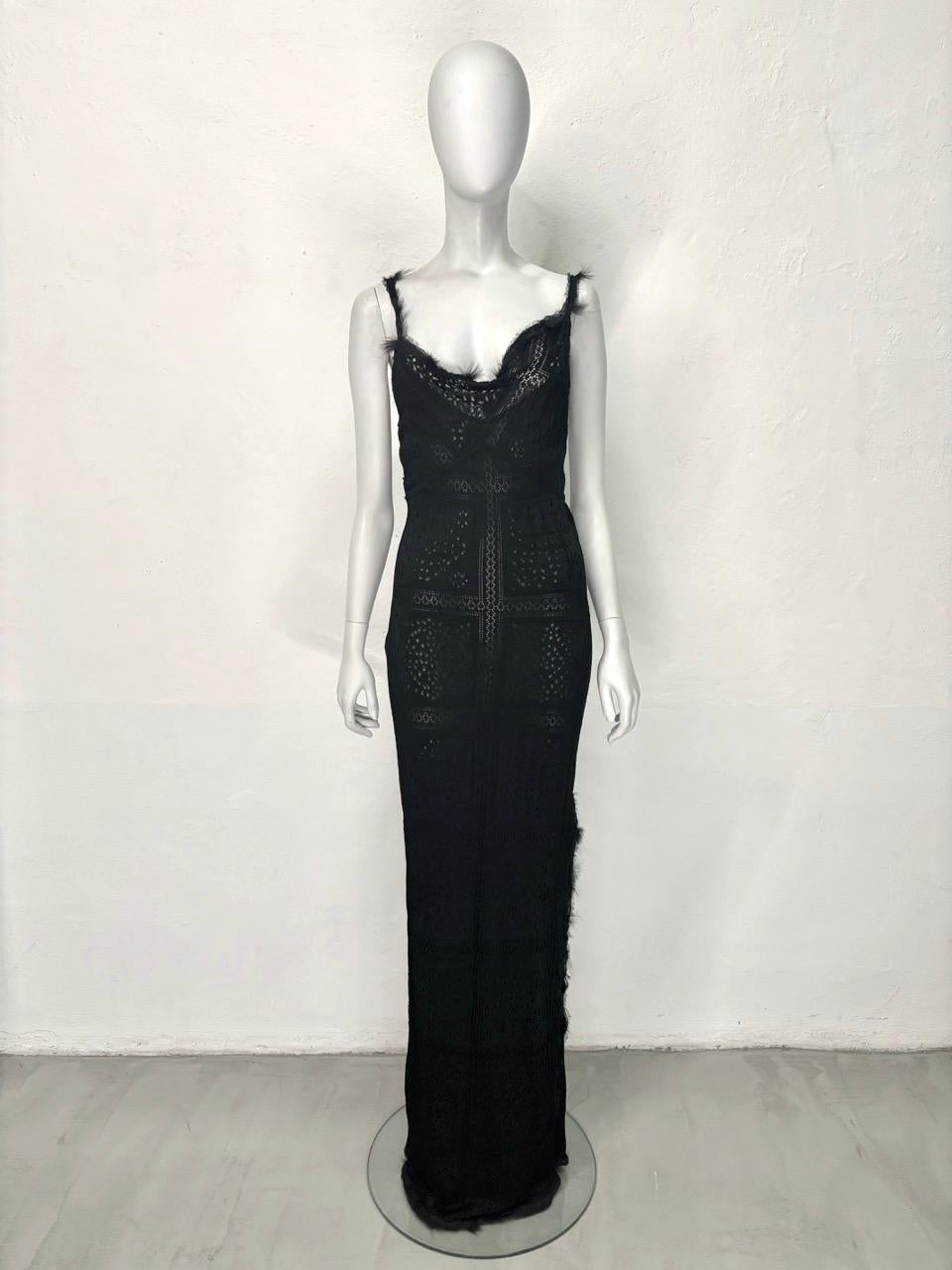 - John Galliano fall-winter 2001 collection
- Sold by Gold Palms Vintage
- Black knitted lace gown
- Black viscose sewn-in slip dress
- Asymmetrical cowl neck
- Fur appliqués trimming
- Side slit
- Size L

Total length: 164 cm / 64.5 inch
Bust