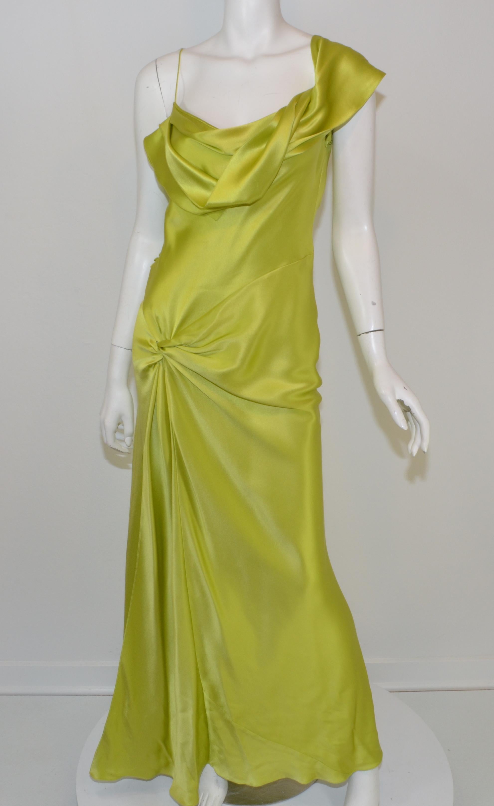 This beautiful gown was designed by John Galliano for Christian Dior during his 15-year tenure with the fashion house. The dress is featured in chartreuse , 100% silk, bias cut design with spaghetti straps and a silk panel draped along the left