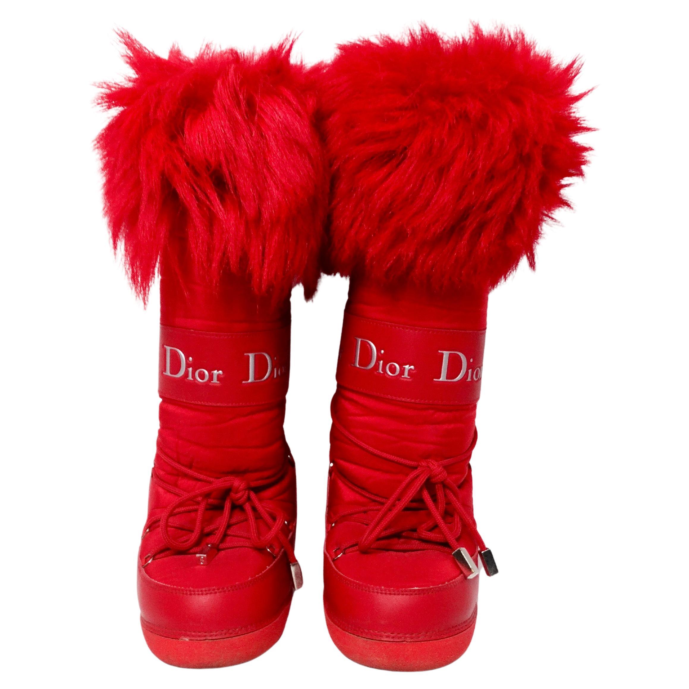 The John Galliano for Christian Dior Red Lace-Up Faux Fur Snow Boots from the Y2K era are a striking example of early 2000s luxury footwear. These boots feature a vibrant red hue that commands attention, complemented by intricate leather trim