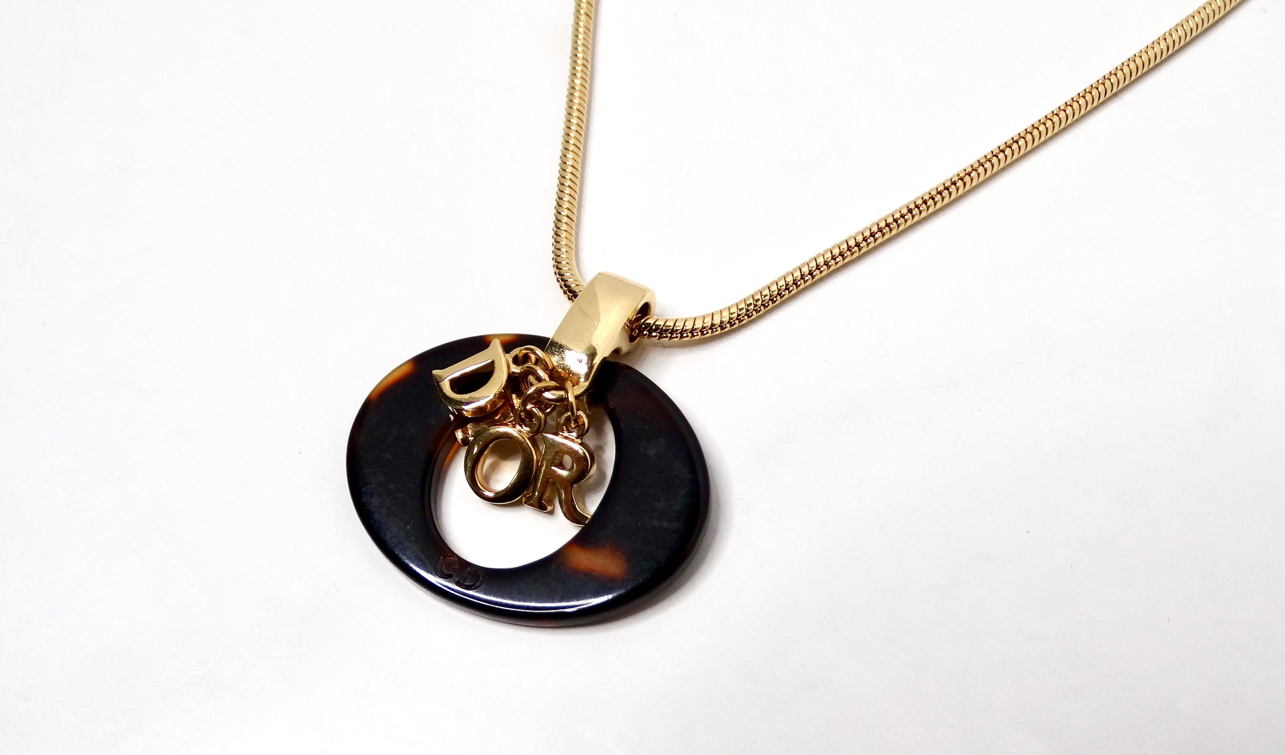 The Y2K John Galliano for Christian Dior Tortoise Pendant Necklace is a striking statement piece that captures the glamor and playful spirit of early 2000s fashion. Its oval-shaped tortoise-style pendant exudes vintage charm, with the classic