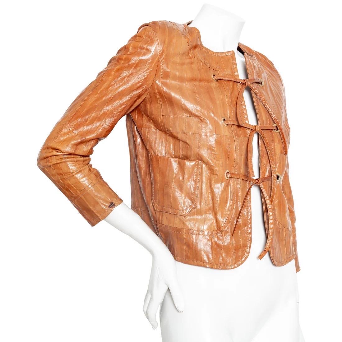 Christian Dior Brown Eel Leather Grommet Jacket

Vintage; circa early 2000s
John Galliano for Christian Dior
Light Brown
Eel leather panels
Collarless, round neckline
Open front with self-tie straps
Gold-tone grommets
Front patch pockets
3/4