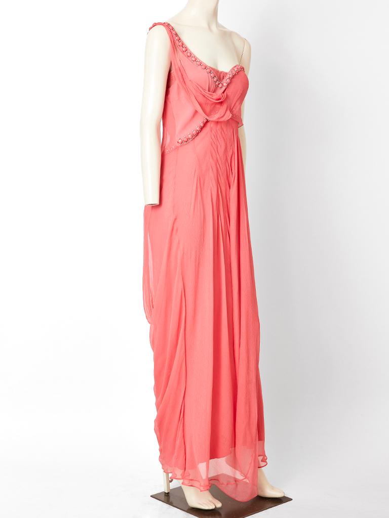 John Galliano for Christian Dior, coral tone, layered, silk georgette, one shoulder, empire waist, gown, having beading and rhinestone embellishment across the neckline and bust. Dress has signature Galliano bias cut.