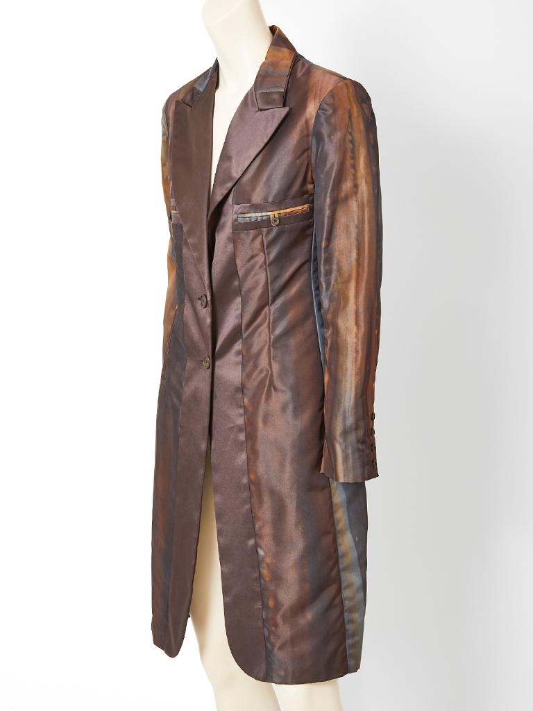 John Galliano for Dior,  fitted, silk taffeta, single button closure coat having a notched lapel collar, breast pockets and a single pocket at the hip. Jacket has tones of coppers and greys with a painterly, brush stroke,  subtle, stripe pattern,