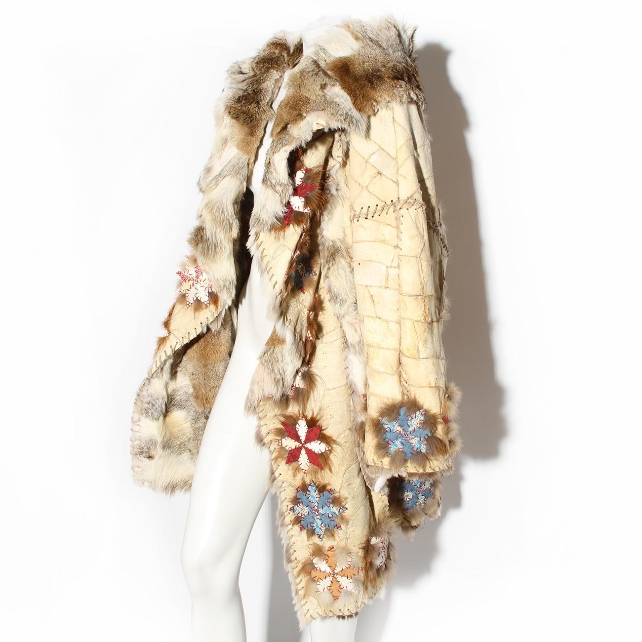 John Galliano Fur Coat 
Fall / Winter 2002 
Look 2 seen on Carmen Kass 
Vintage 
Made in France 
Exterior is tanned suede leather in a patchwork style
Interior of jacket is lined in fur 
Shawl style collar 
Leather thread stitch details 
Geometric