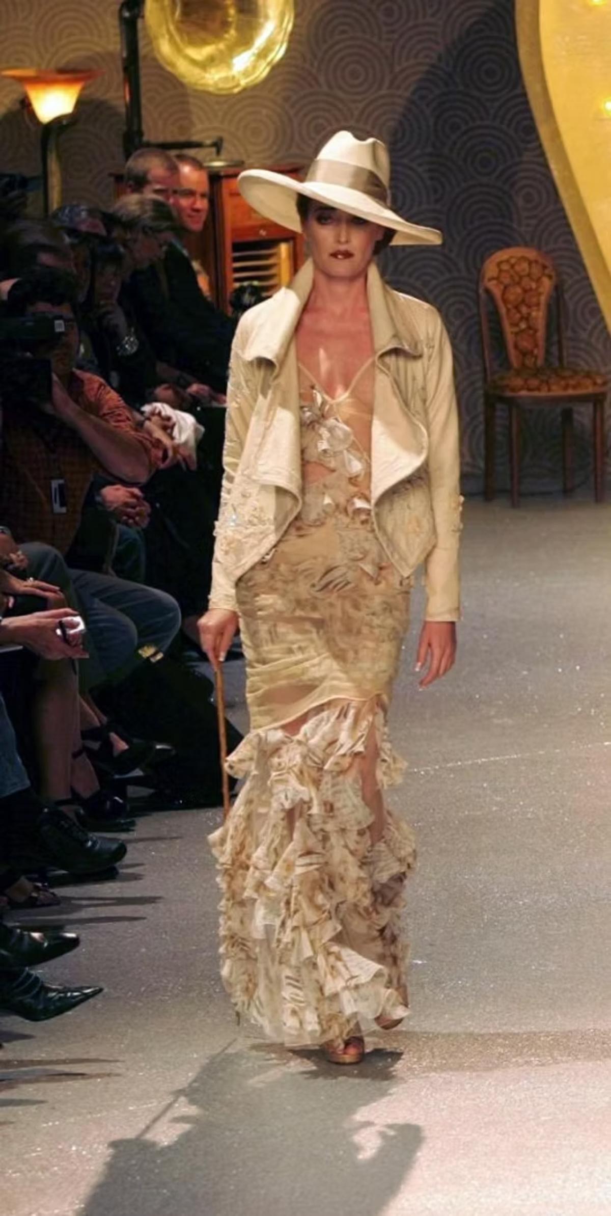 John Galliano tulle and silk gown, from the Spring/Summer 2006 collection. As seen on the runway. Features sheer mesh draped over panels of Gazette printed silk ruffles. Rihanna wore an identical dress to the launch of Fenty Hair,