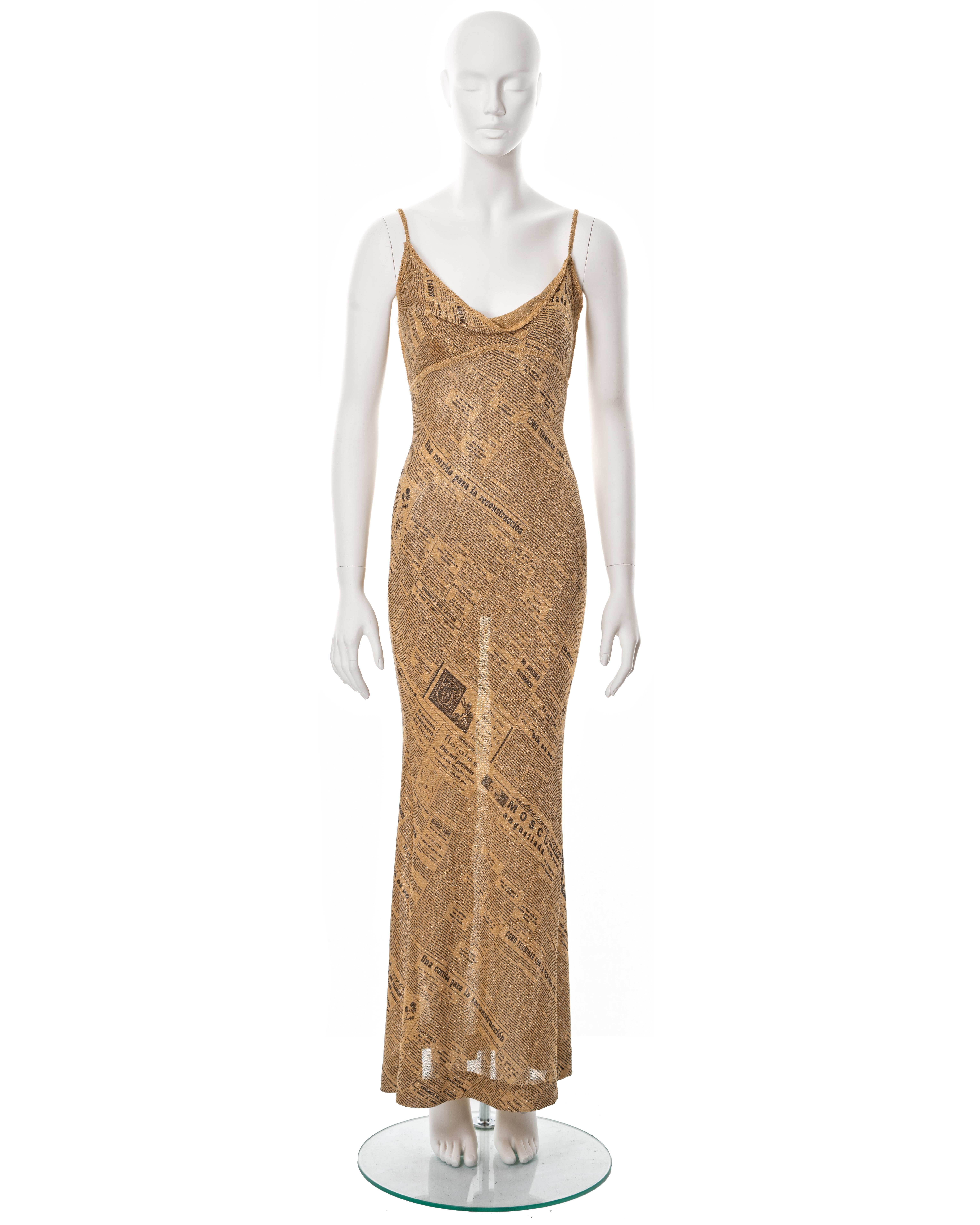 ▪ John Galliano evening dress
▪ Spring-Summer 2001
▪ Constructed from gold bias-cut knitted lurex with a black newsprint motif
▪ Asymmetric cowl neck
▪ Spaghetti straps
▪ Flared maxi skirt
▪ Size approx. Medium 
▪ Made in France

All photographs in