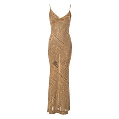 John Galliano gold lurex bias cut evening dress with newsprint motif, ss 2001