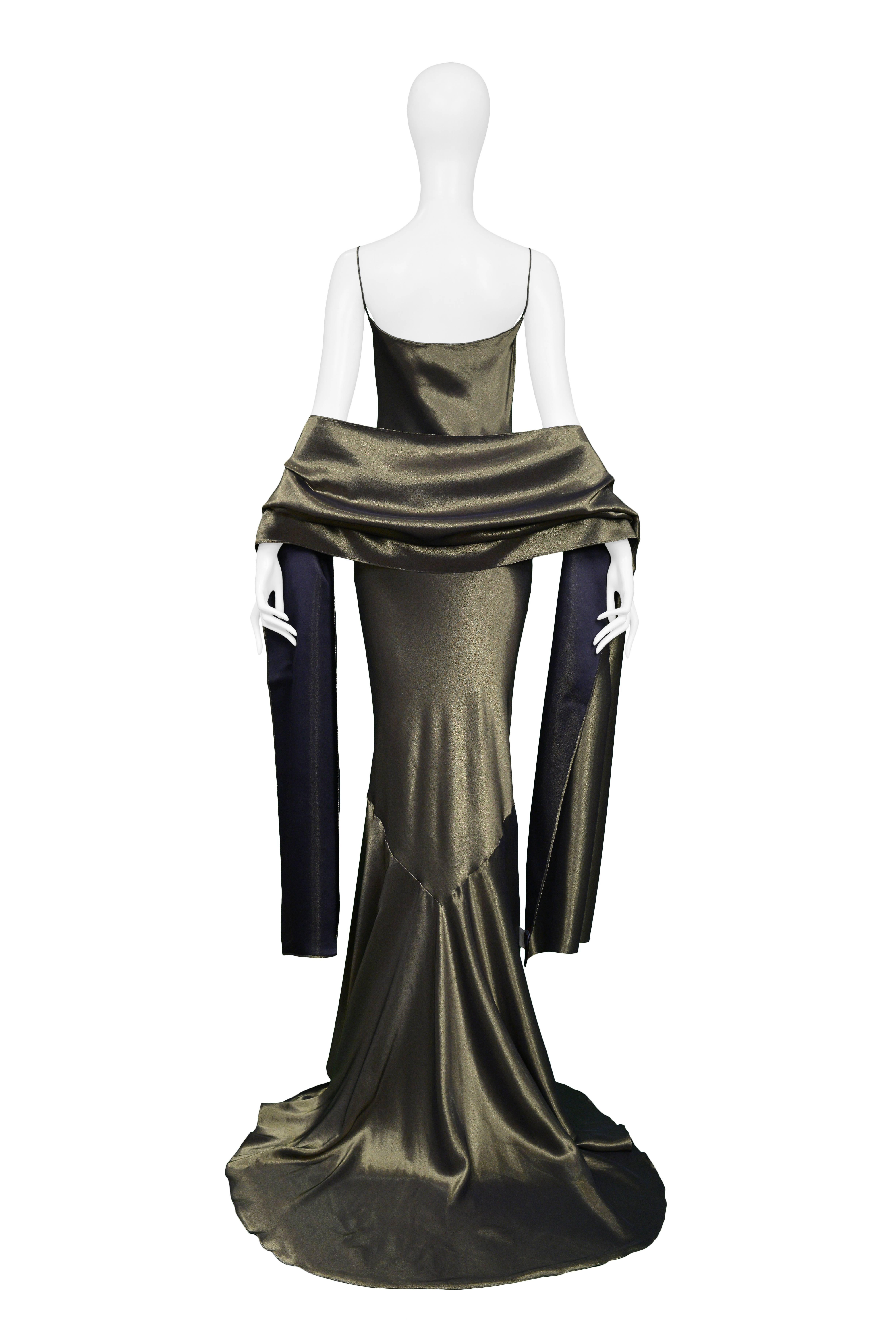 John Galliano  
Gold Slip Gown & Wrap Ensemble 1997

Condition : Excellent Vintage Condition
Vintage John Galliano liquid gold lamé slip gown with matching shawl. The gown features spaghetti straps and a fishtail train. Collection Autumn / Winter