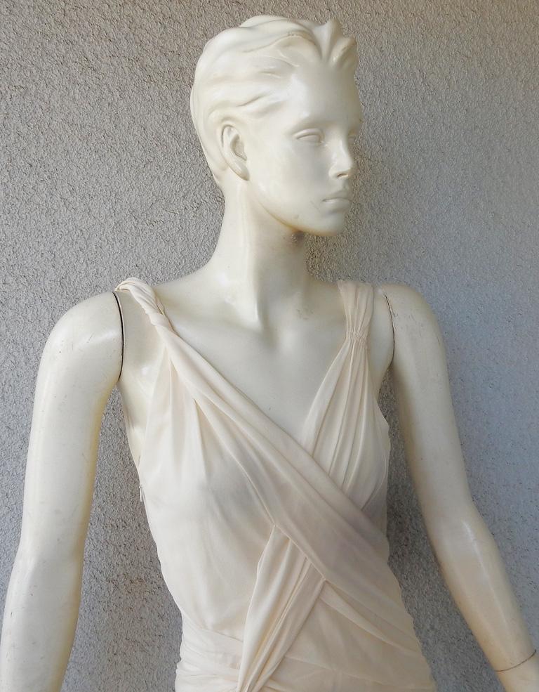 John Galliano circa 2000 angelic elegant evening gown inspired by Grecian fashion.   Asymmetrically fashioned in ivory silk chiffon delicately crafted in crisscross draped bodice.  Long skirt easily and delicately drapes the body in a perfect