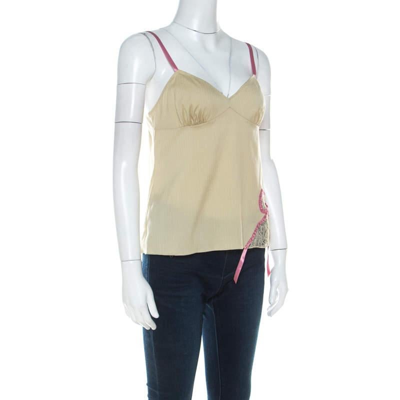 This sleeveless Camisole top from John Galliano is perfect to complement your chic style! The top features thin straps and lace bow detail. Pair it with skirts or jeans for a casual day out.