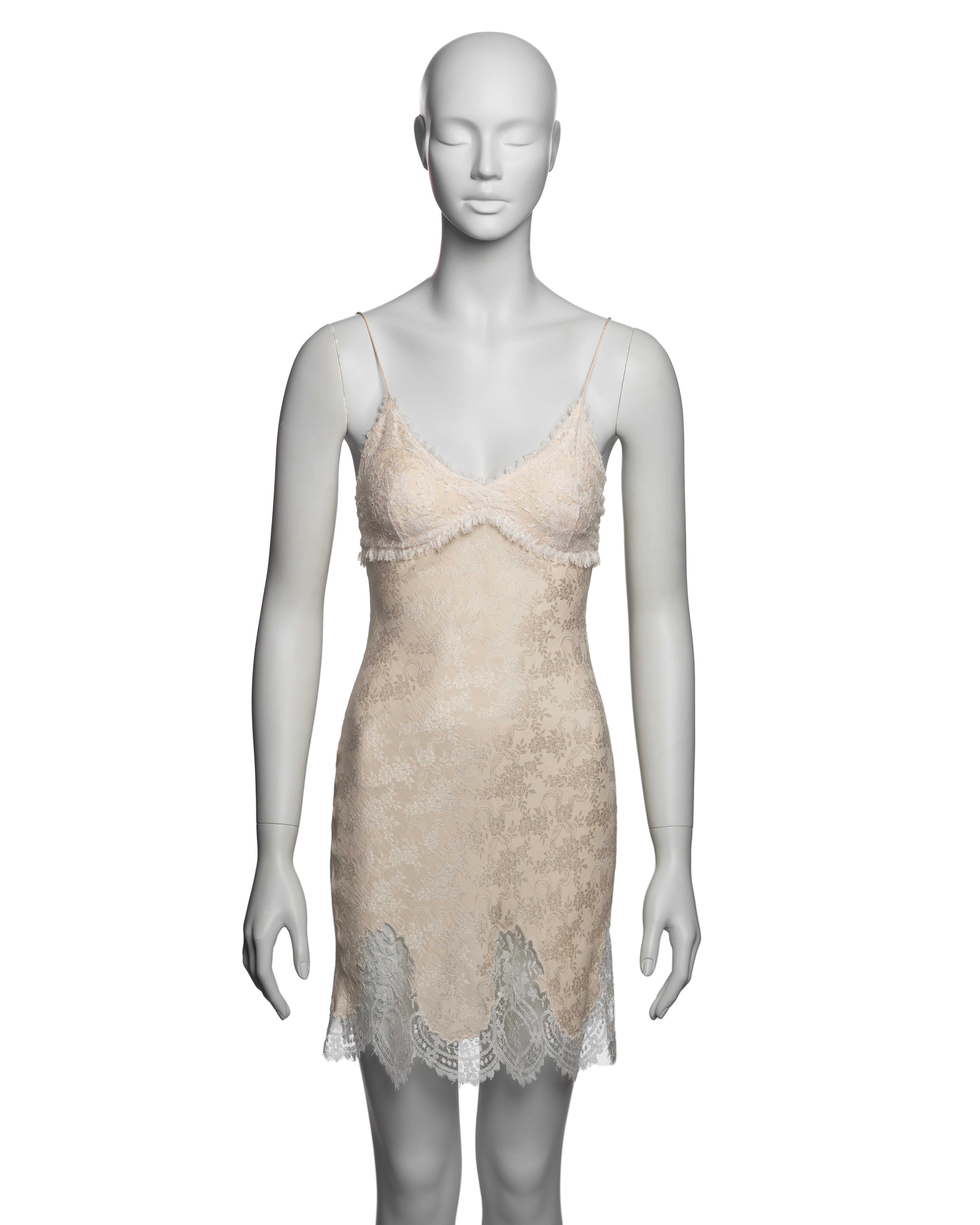 John Galliano evening mini slip dress features delicate ivory lace trim along the hem, neckline, and bust overlay, paired with a fitted body of floral-patterned silk damask. 

▪ Brand: John Galliano
▪ Creative Director: John Galliano
▪ Collection: