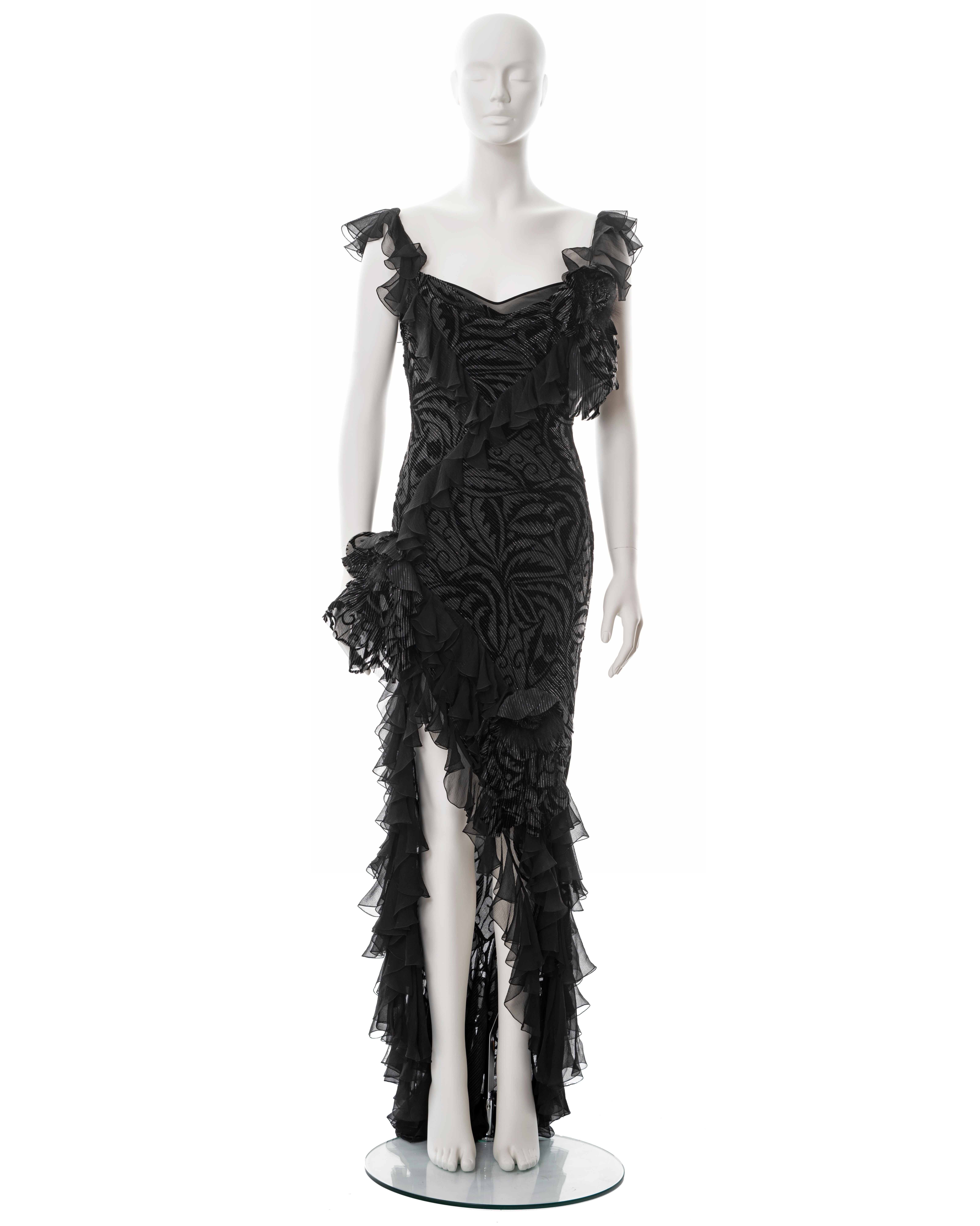 ▪ John Galliano evening dress
▪ Sold by One of a Kind Archive
▪ Fall-Winter 2003
▪ Constructed from bias-cut metallic black and silver viscose-silk chiffon
▪ Ruffled high-low skirt and trim 
▪ Chiffon and fur corsages 
▪ FR 40 - UK 12 - US 6
▪ Made