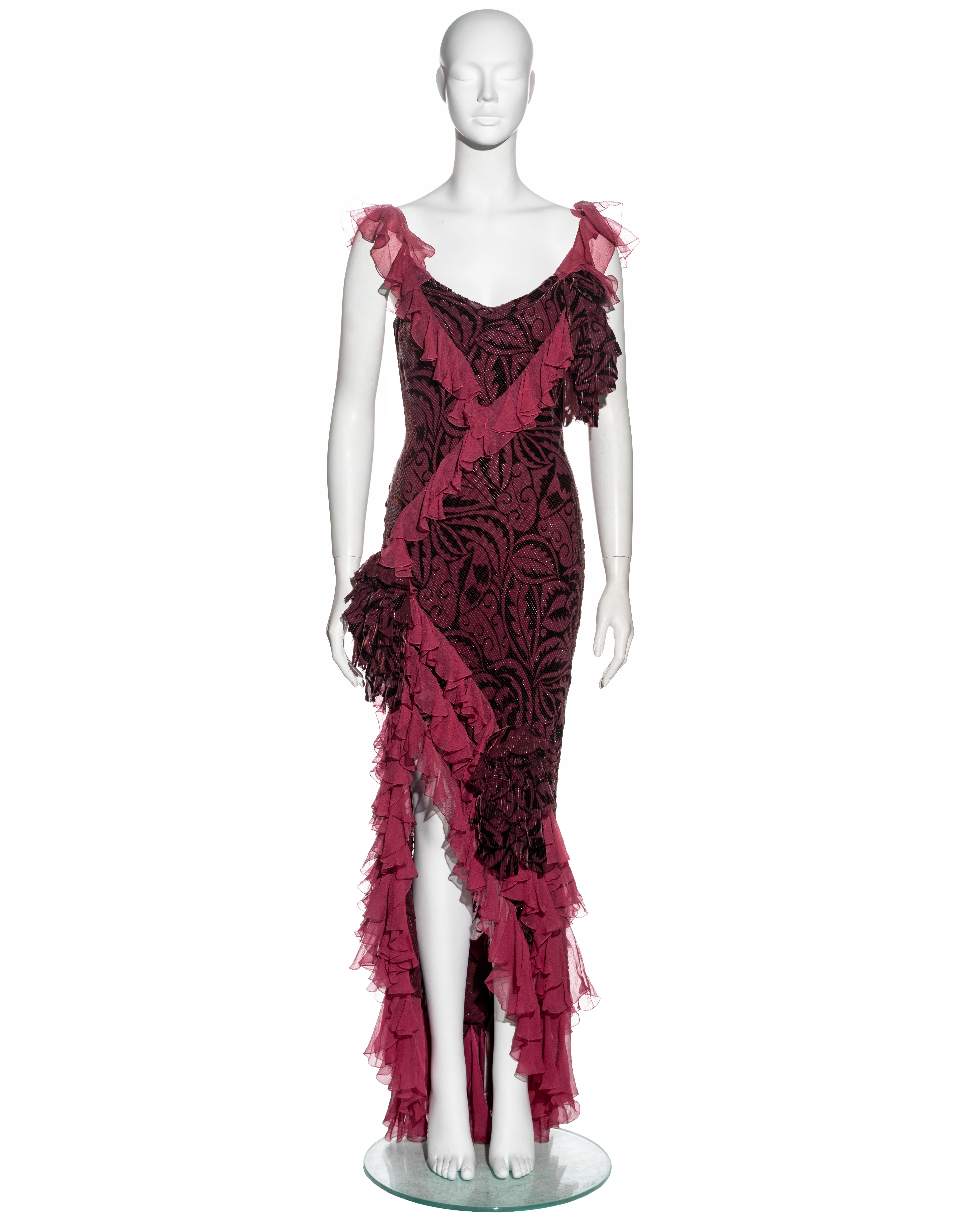▪ John Galliano evening dress
▪ Sold by One of a Kind Archive
▪ Constructed from bias-cut metallic plum and burgundy viscose-silk chiffon
▪ Ruffled trims and skirt 
▪ Chiffon and fur rosettes 
▪ Size FR 40 - US 12 - US 6
▪ Fall-Winter 2003
▪ Made in